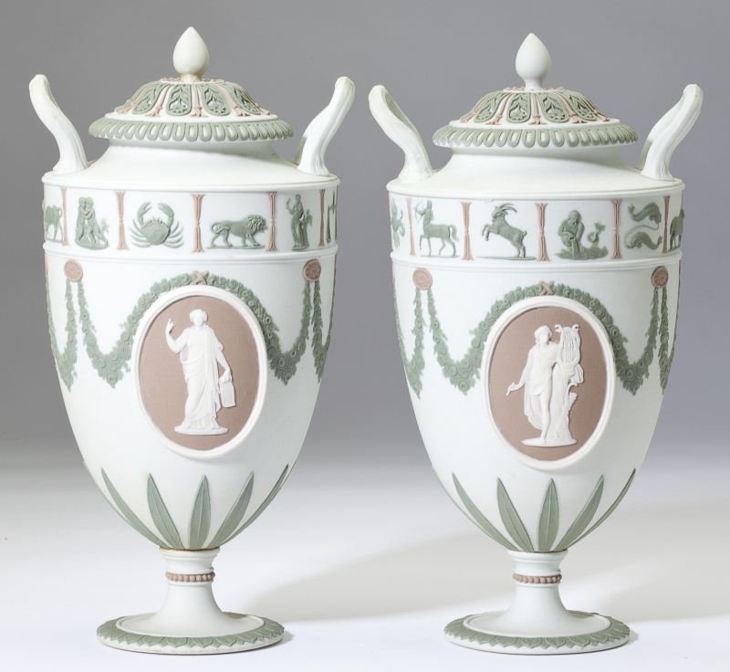 A Pair of Wedgwood Jasperware Lidded Urns: A Pair of Wedgwood Jasperware Lidded Urnsattractive coloration of off-white, mauve and olive featuring Greek goddess plaques, a zodiac frieze and foliate motifs, stamped "Wedgwood V Y", with bolted fo