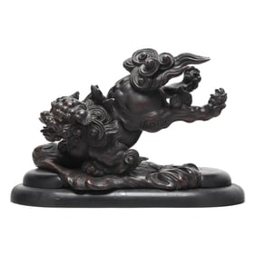 An Asian Carved Wood Foo Lion in Base