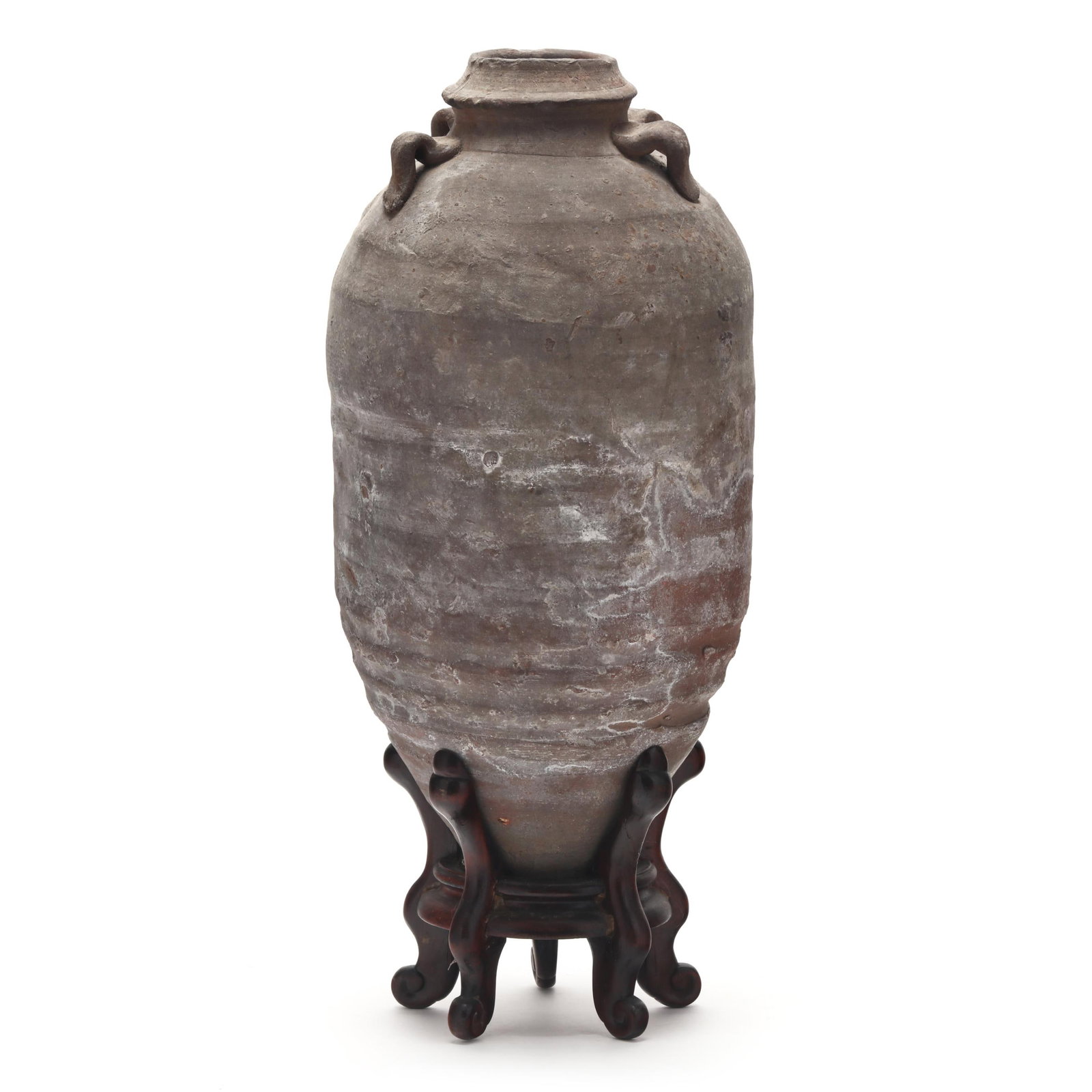 A Chinese Warring States Stoneware Amphora Jar: A Chinese Warring States Stoneware Amphora JarWarring States period (475–221 BCE), stoneware, with bottle rim and four strap handles to shoulder, body tapers to a narrow foot, presented resting in a