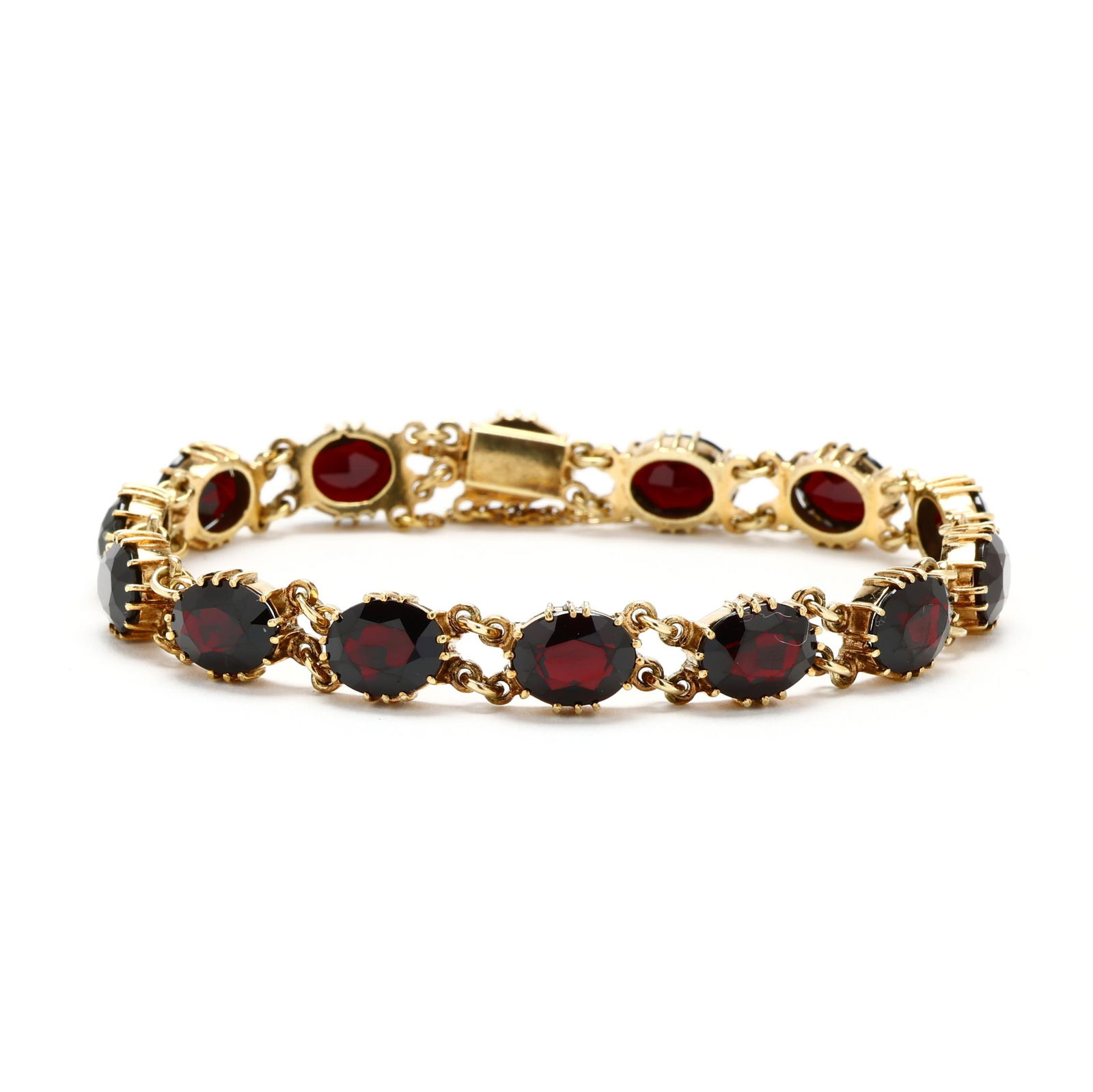 Vintage Gold and Garnet Line Bracelet, Germany: Vintage Gold and Garnet Line Bracelet, Germanygold bracelet set with (14) oval cut garnets weighing approximately 22.0 total carats in prong settings, separated by round links, completed with an integ