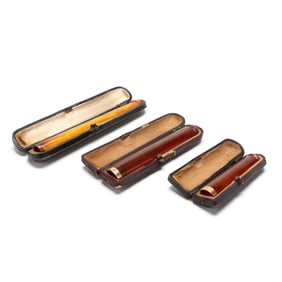 Three Cased Art Deco Amber and 14K Gold Cigarette Holders, including Tiffany & Co.