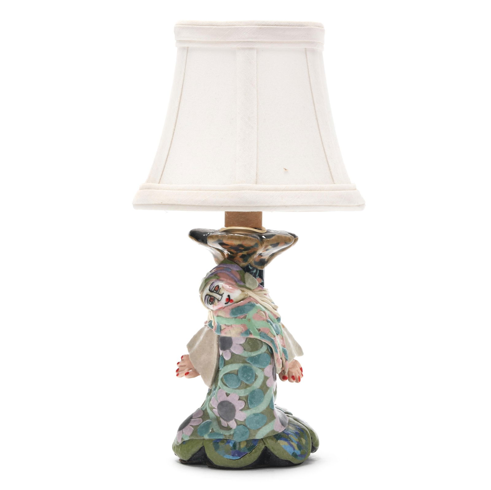 Jane Peiser (NC), Art Pottery Boudoir Lamp: Jane Peiser (NC), Art Pottery Boudoir Lamplate 20th century, glazed ceramic, formed as a windswept figure leaning against a candlestick atop a petal form scalloped rim, the whole decorated in multicol