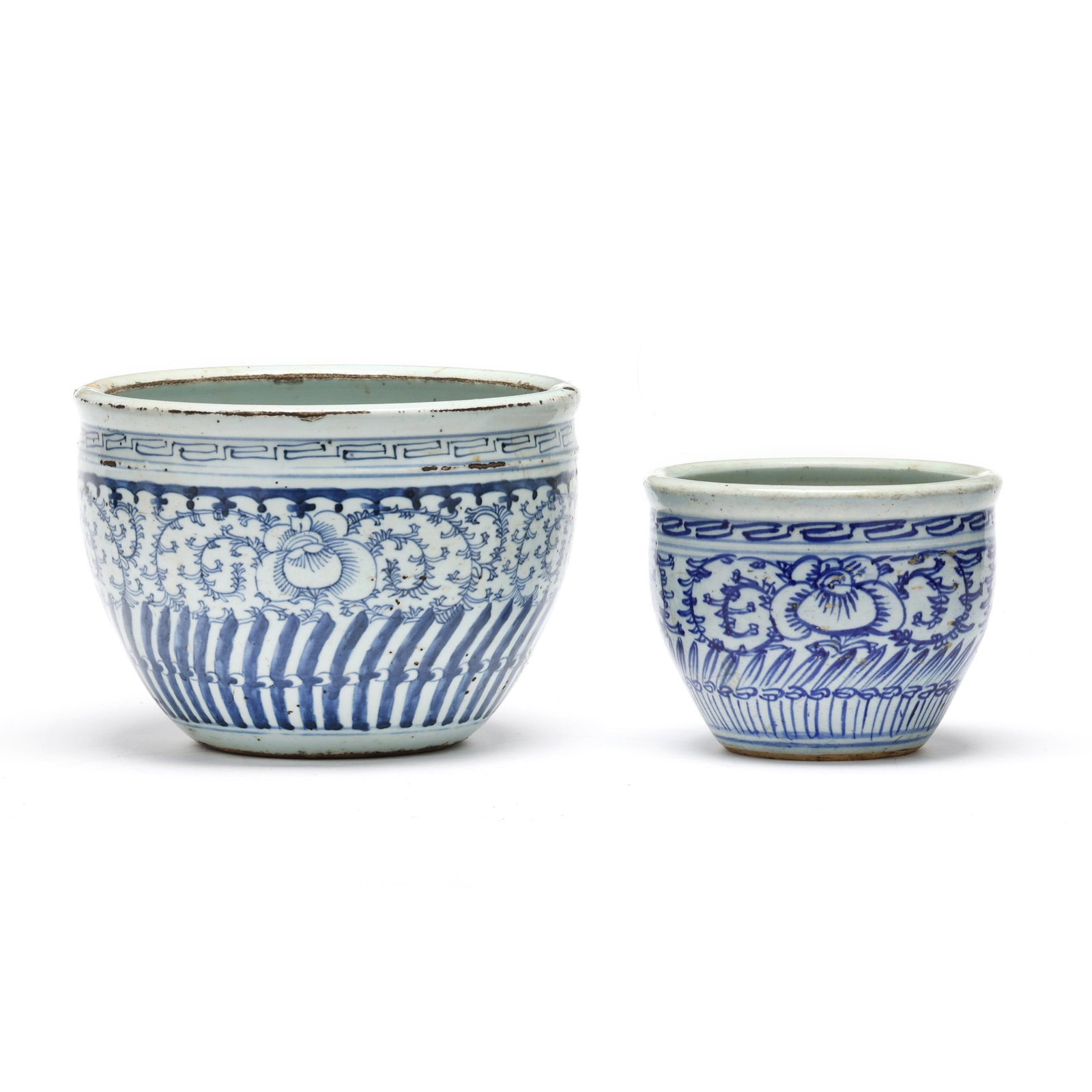 Two Chinese Blue and White Porcelain Jardinieres: Two Chinese Blue and White Porcelain Jardinieres late 19th century, porcelain hand painted in blue underglaze with lotus flowers and scrolling foliage, unglazed to the underside. Largest 7 x 9 3/4 in.