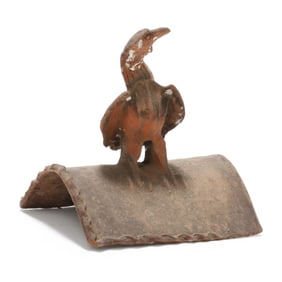 A Terracotta Roof Tile Featuring an Alert Raptor