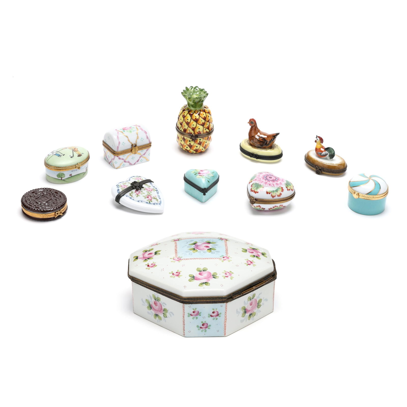 Limoges, Ten Porcelain Pill Boxes and a Dresser Box: Limoges, Ten Porcelain Pill Boxes and a Dresser BoxFrance, mid- to late 20th century, (11) hand-painted porcelain boxes: (10) pill boxes in different forms including a Tiffany & Co. private stock "Hap