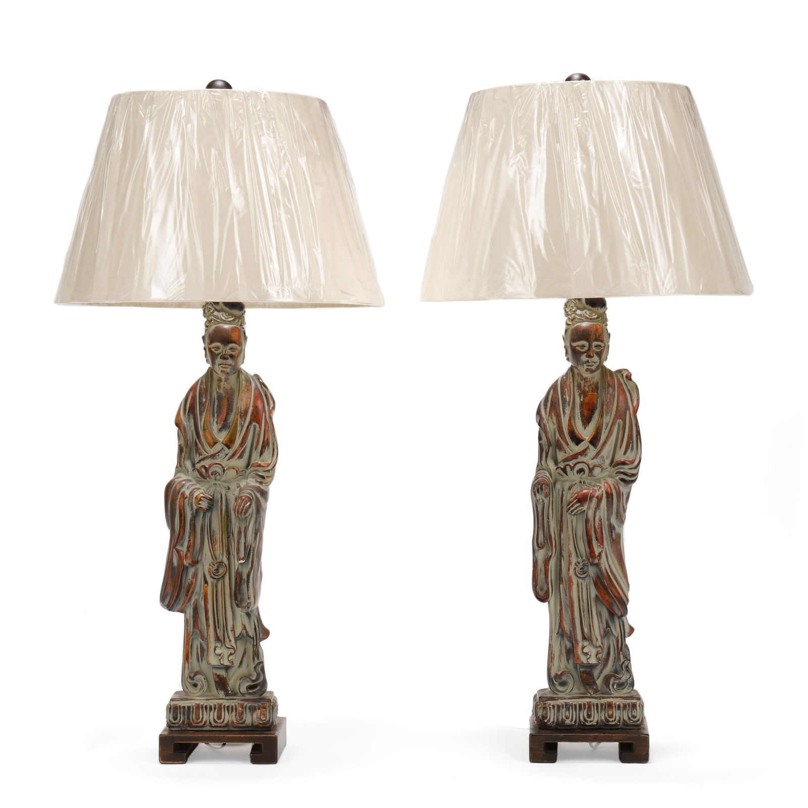 Pair of Frederick Cooper Ceramic Guanyin Table Lamps with Shades: Pair of Frederick Cooper Ceramic Guanyin Table Lamps with ShadesAmerican, late 20th century, each with gessoed faux bronze finish and mounted to conforming carved wood stands and wood ball finials, in
