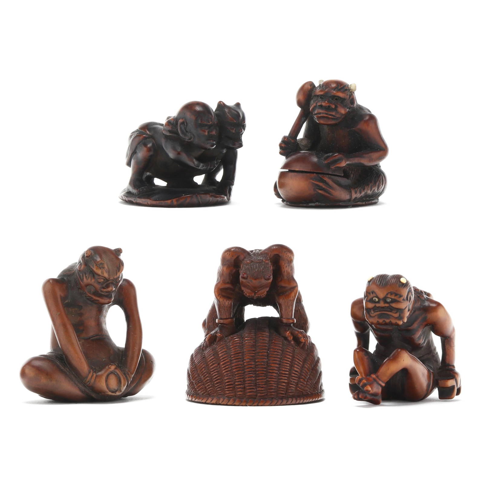 A Group of Five Japanese Carved Boxwood Netsuke of Oni