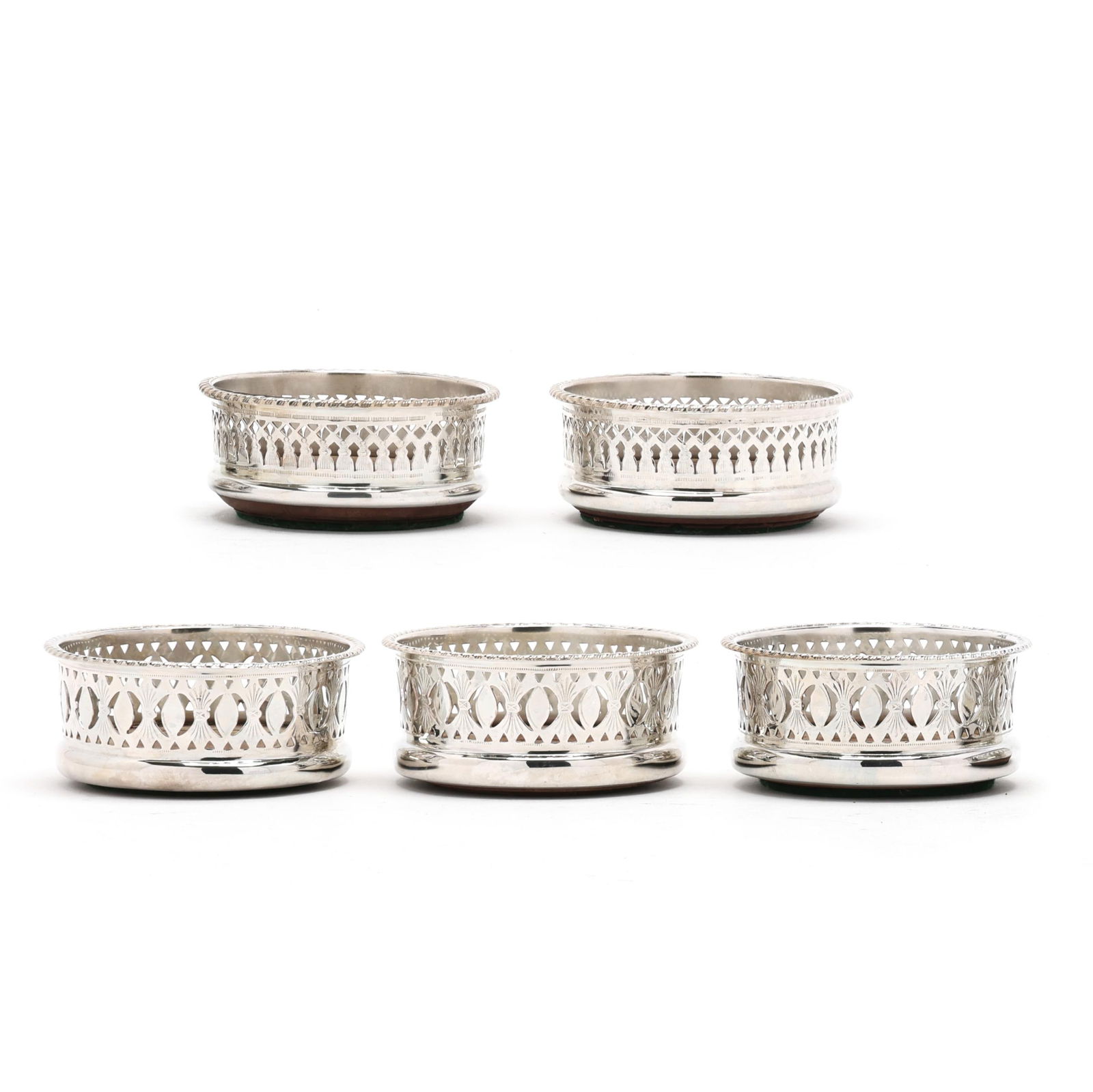 Set of Five English Silver-Plated Bottle Coasters: Set of Five English Silver-Plated Bottle Coastersnot marked, with wooden insets, various reticulated patterns, not monogrammed. 1 1/2 x 3 3/4 in. dia. Additional high-resolution photos are available