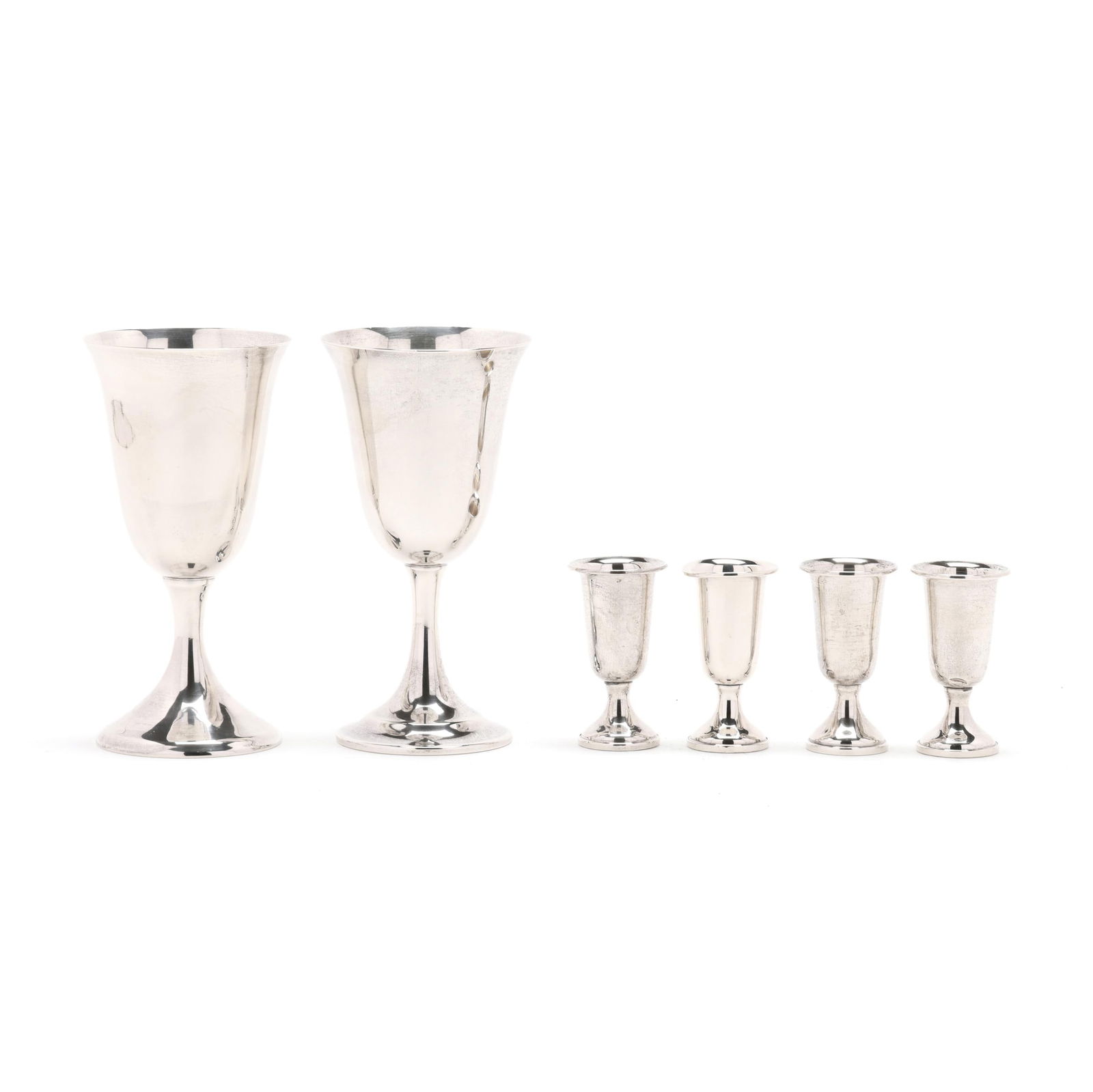 Two Sterling Silver Goblets and a Set of Four Cordials: Two Sterling Silver Goblets and a Set of Four Cordialsincludes an International Lord Saybrook goblet, pattern number 11950; a Reed & Barton sterling silver goblet, pattern number X117; and (4) cordial