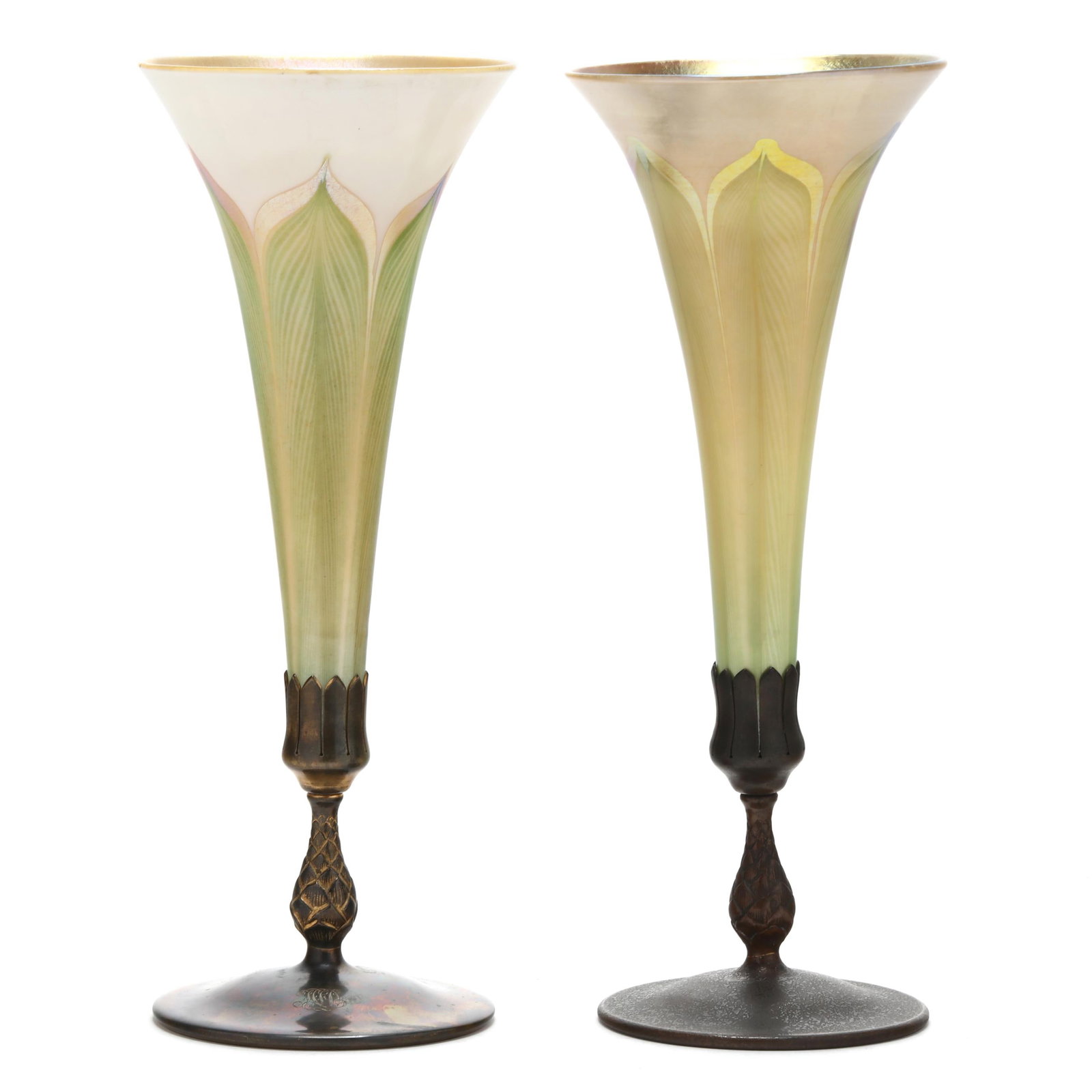 Near Pair of Tiffany Studios Bronze and Glass Trumpet Vases: Near Pair of Tiffany Studios Bronze and Glass Trumpet VasesNew York, circa 1910, blown gold and white iridescent glass with pulled green feather motif set into patinated bronze stands, one vase featur