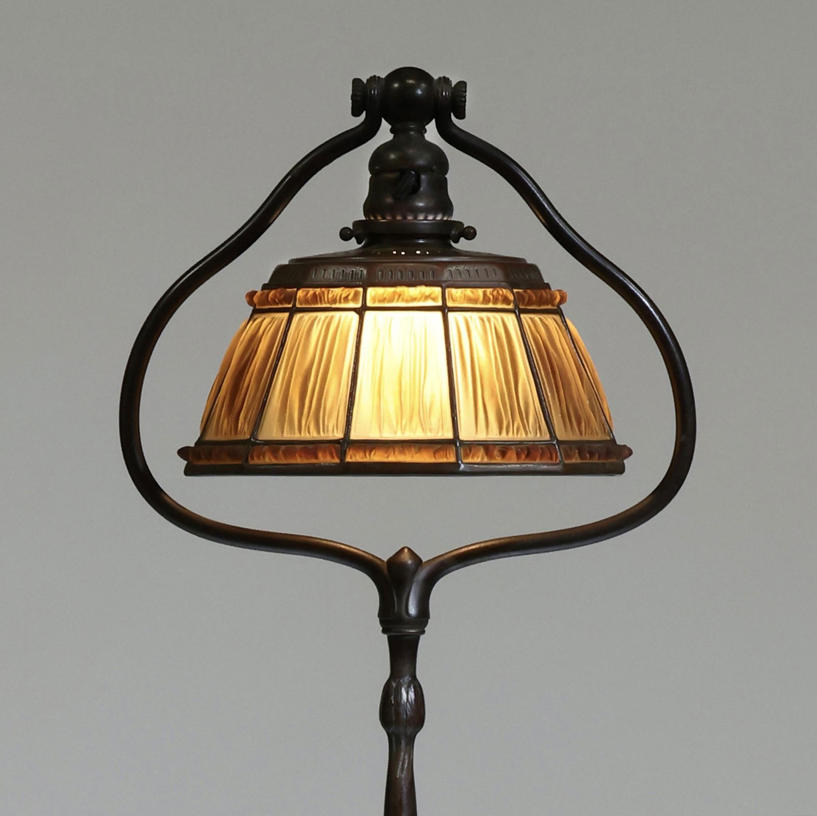 Tiffany Studios, Favrile Fabrique (Linenfold) Floor Lamp: Tiffany Studios, Favrile Fabrique (Linenfold) Floor LampNew York, circa 1915, 9 3/4-inch diameter dodecagonal leaded glass shade featuring ten caramel colored 'Favrile fabrique' panels framed above an