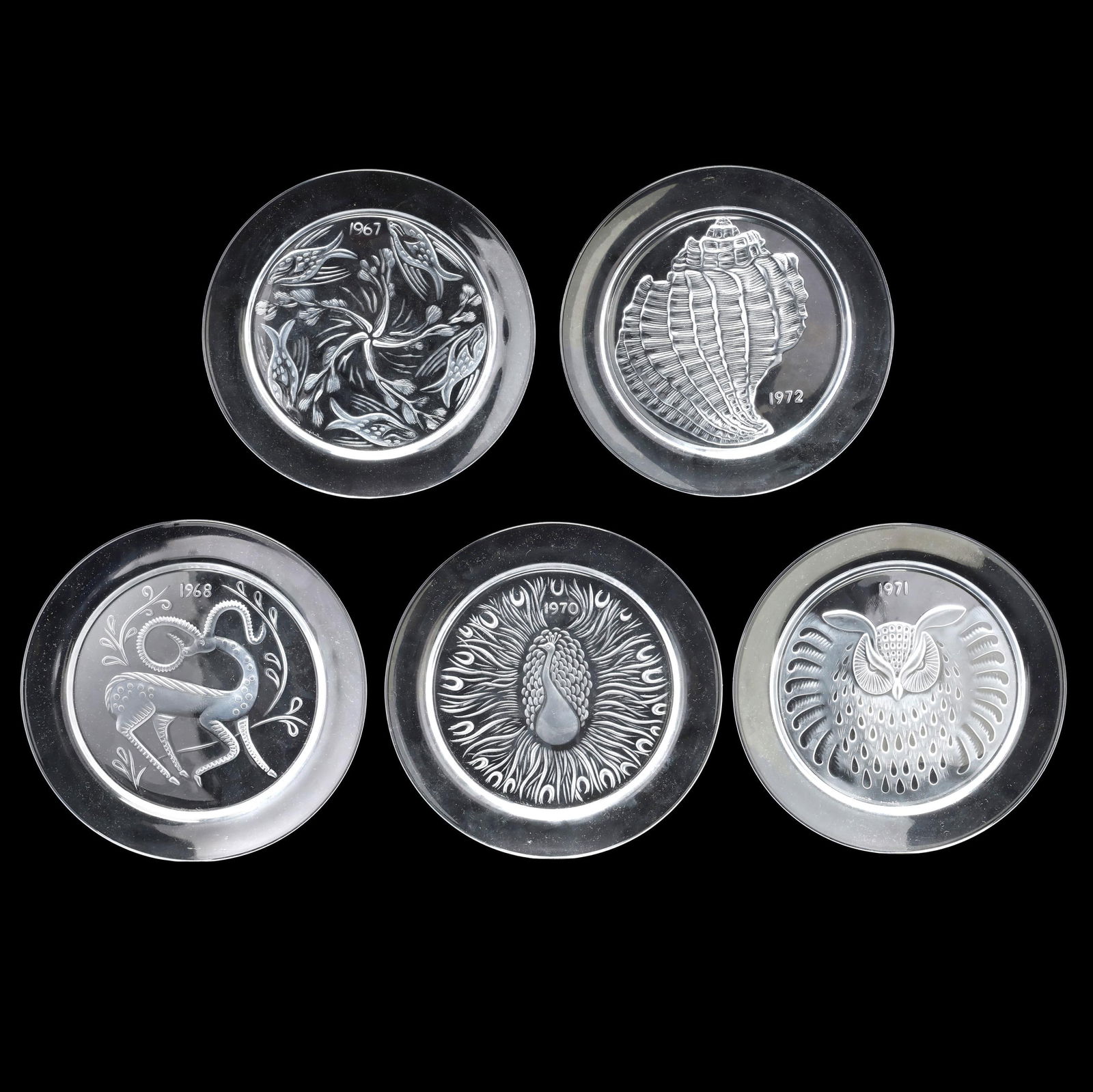 Five Lalique Crystal Calendar Plates: Five Lalique Crystal Calendar PlatesFrance, including 1967, 1968, 1970, 1971, 1972, signed, with boxes. 8.25 in. diameter Collection of Michael and Ingrid Kelly, Worldwide Gallery Antiques, Fredericks