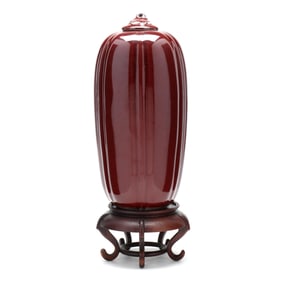 A Tall Porcelain Gourd Form Sang de Boeuf Vase with Cover