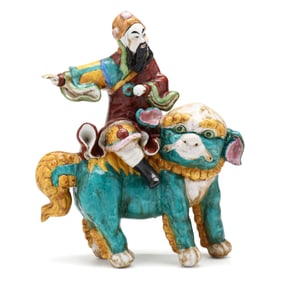 A Chinese Porcelain Tang Style Figure Astride A Foo Lion