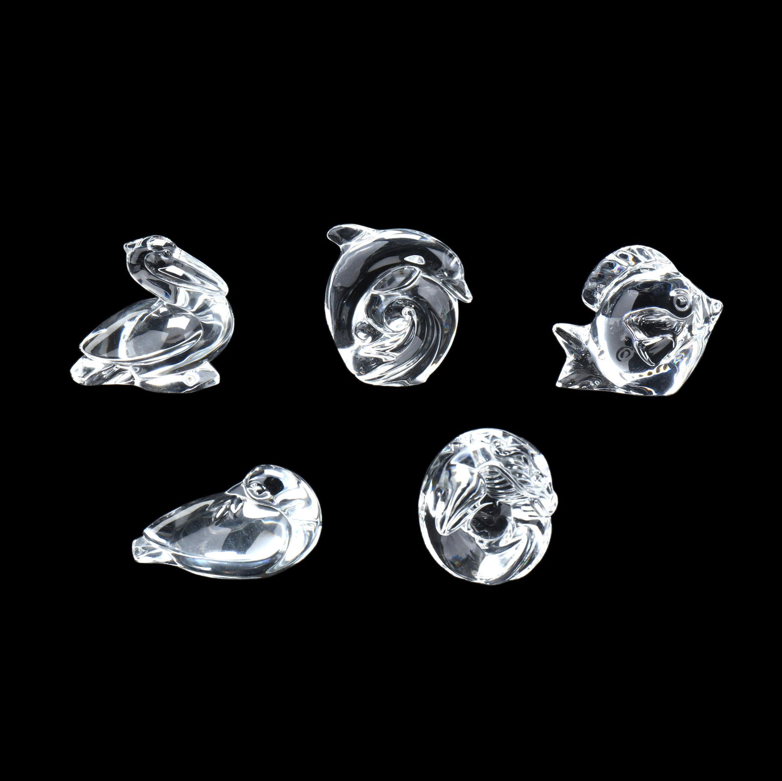 Five Assorted Steuben Crystal Animals: Five Assorted Steuben Crystal AnimalsNew York, late 20th century, including a peace dove hand cooler, dragon hand cooler, dolphin hand cooler, pelican and a fish, signed. 2.75 in. Private Collection,