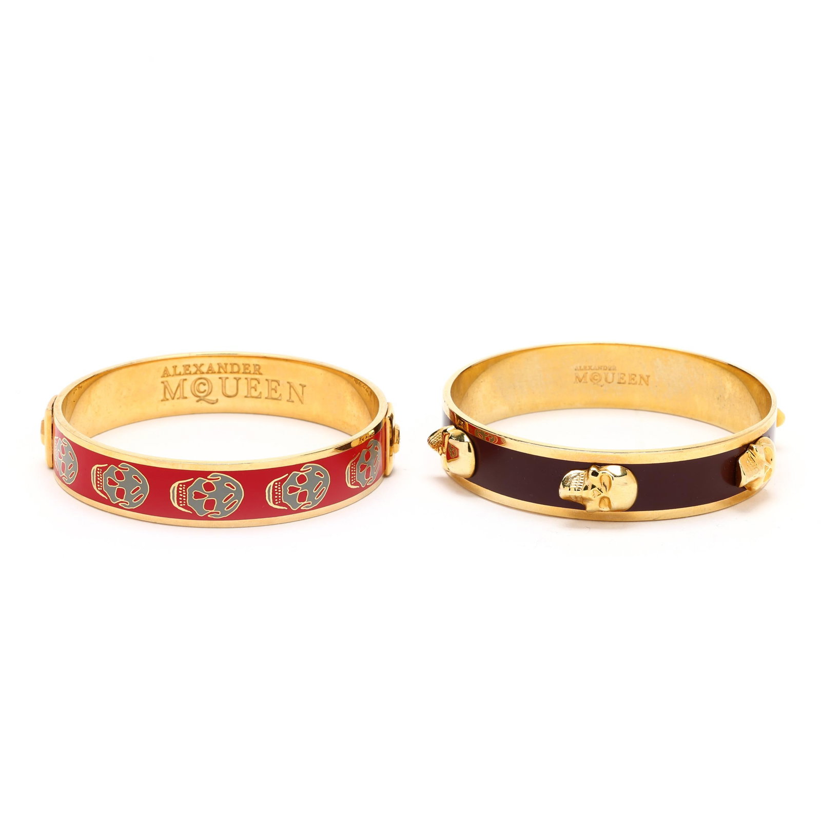 Two Gold-Tone Bangle Bracelets, Alexander McQueen: Two Gold-Tone Bangle Bracelets, Alexander McQueento include: one with gray enamel skulls on a red enamel background, signed and stamped made in China (.5 x 7.75 in. interior circumference); and one wi