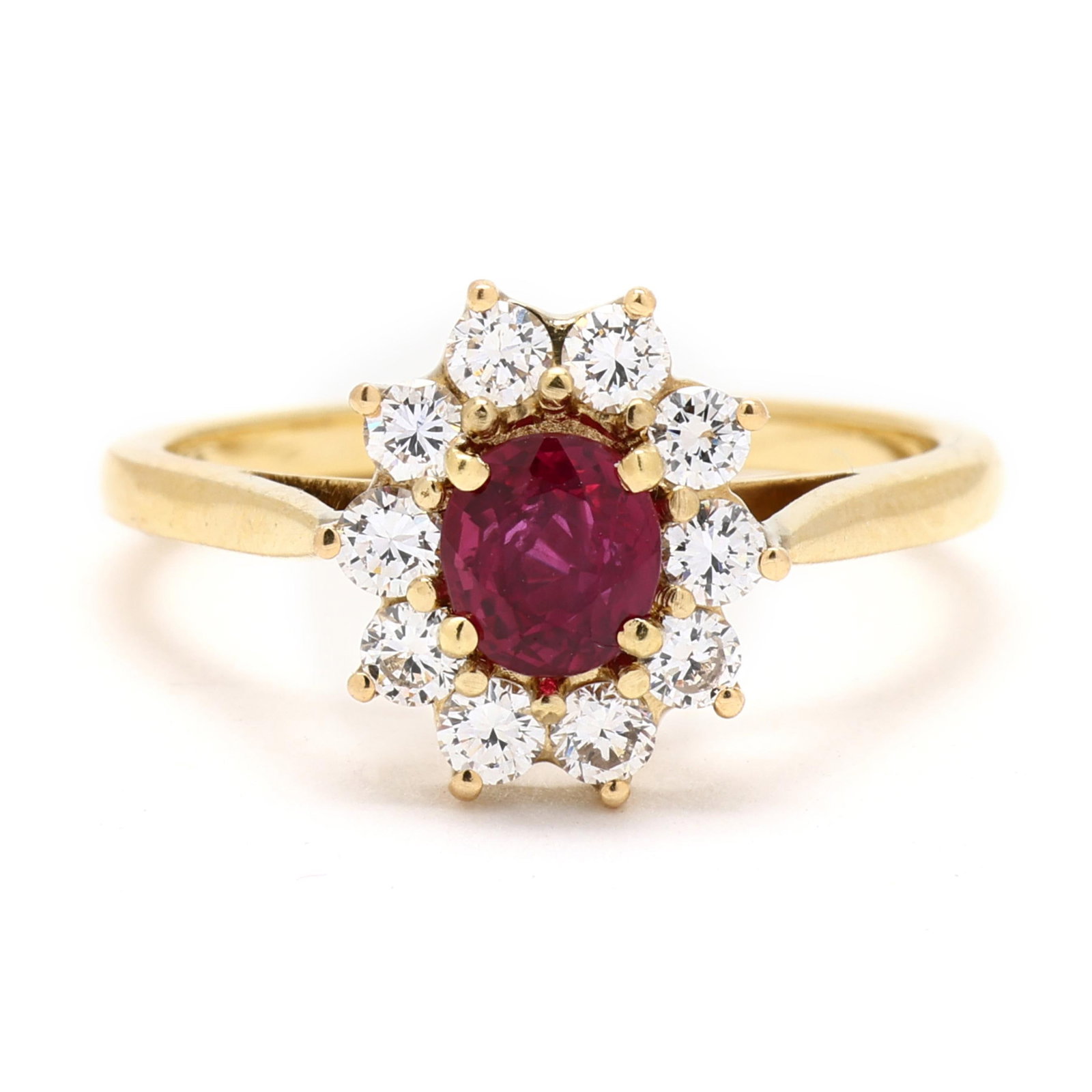 Gold, Ruby, and Diamond Ring: Gold, Ruby, and Diamond Ringcentered on an oval cut ruby (5.0 x 4.5 x 3.0mm) weighing approximately .56 carat within a halo of full cut round diamonds weighing approximately .40 total carat (G-H color