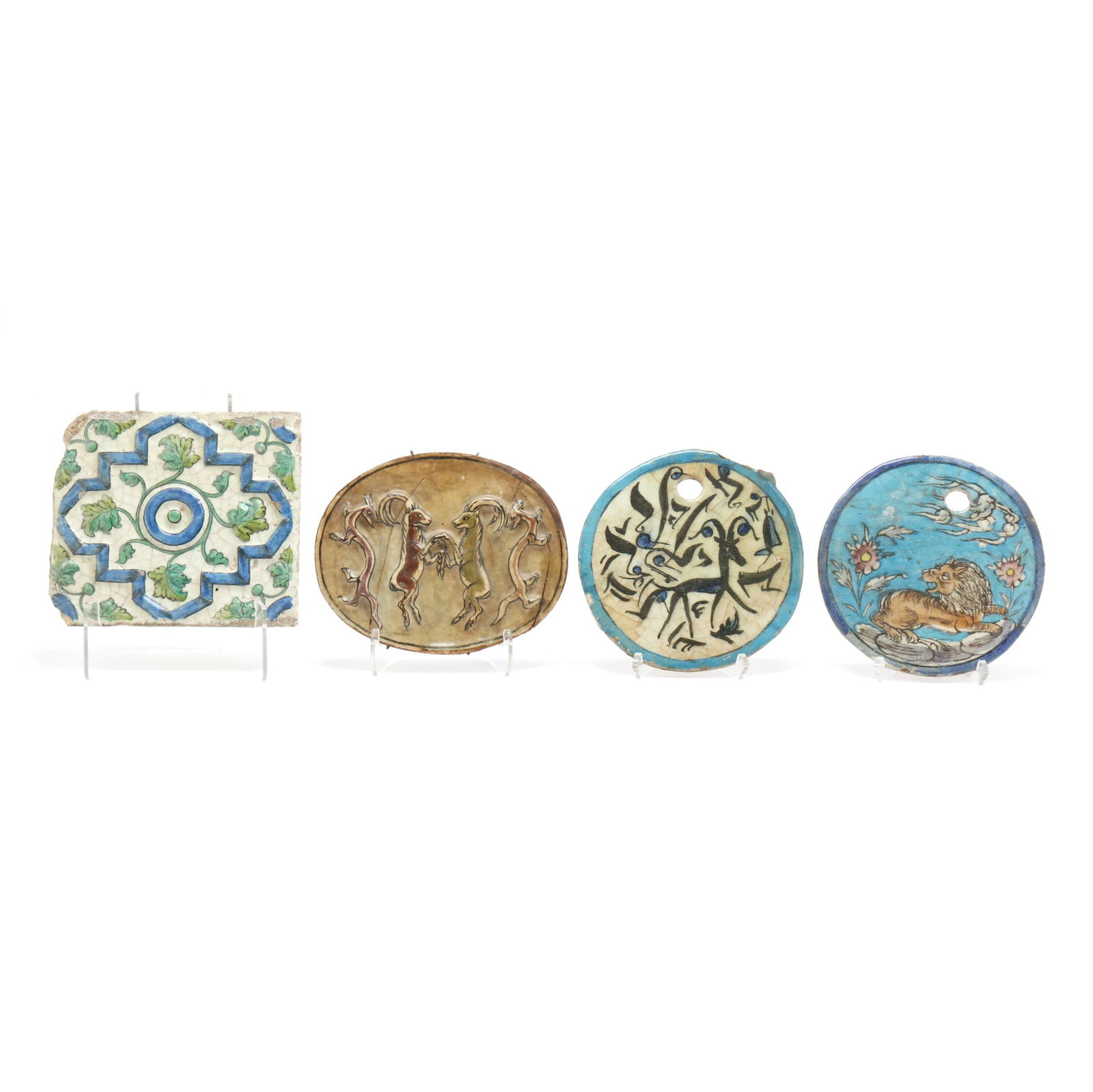 A Group of Four Ceramic Persian Tiles: A Group of Four Ceramic Persian Tiles19th century, molded and glazed earthenware tiles featuring animals and floral and foliate motifs. Largest 9 3/4 x 8 3/4 in. Additional high-resolution photos are