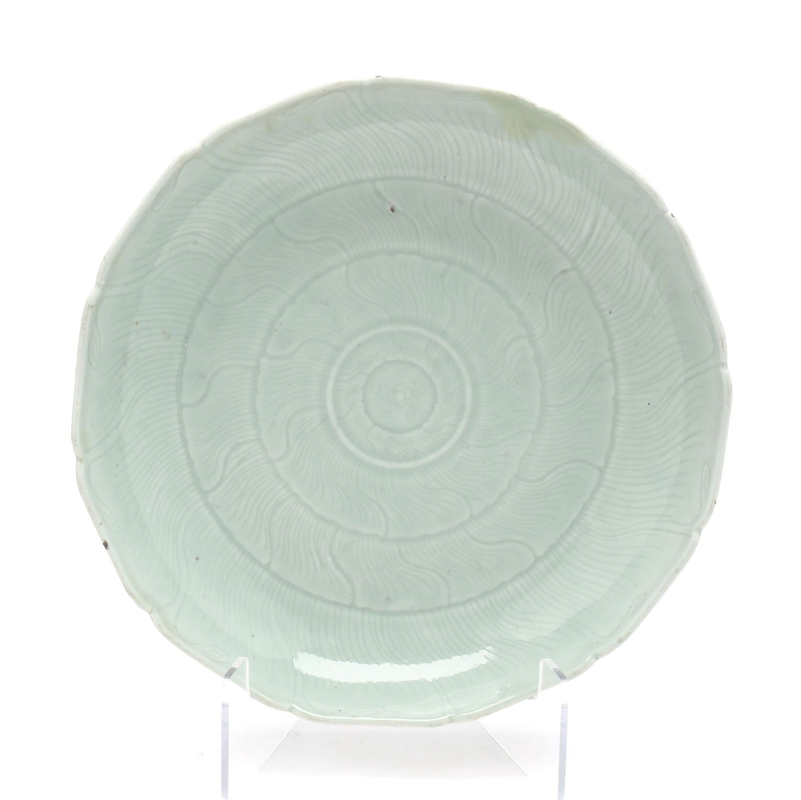 A Large Chinese Celadon Glazed Lotus Blossom Dish: A Large Chinese Celadon Glazed Lotus Blossom Dish 20th century, a porcelain charger with light celadon glaze etched lotus blossom decoration radiating out from the center, repeats on the exterior side
