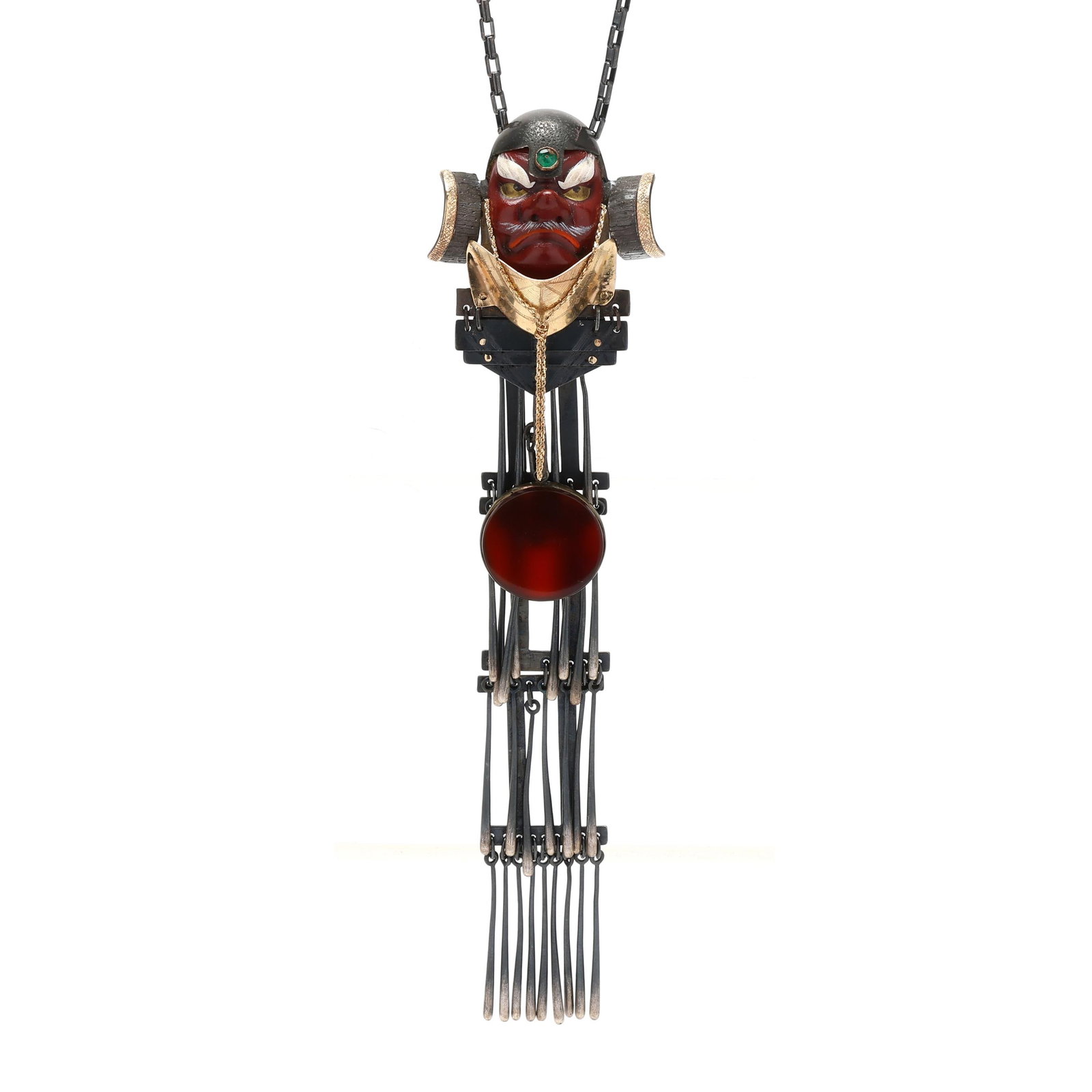 Japanese Tengu Mask Motif Necklace, Mary Ann Scherr: Japanese Tengu Mask Motif Necklace, Mary Ann Scherrred-painted Tengu mask with silver and gold armor, the helmet set with a round cabochon cut emerald, suspending a round tablet cut carnelian drop and