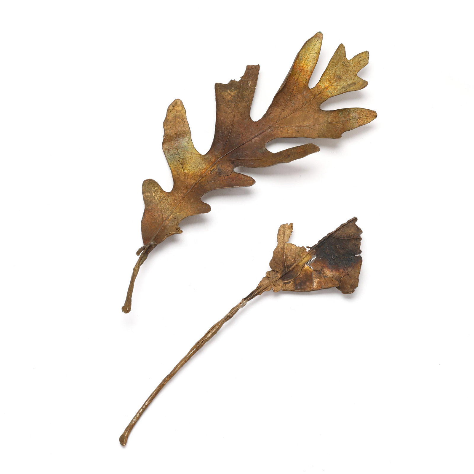 Two Copper Leaf Brooches, John Iversen: Two Copper Leaf Brooches, John Iversento include: one in the form of a white oak leaf, signed and numbered 172, XRF testing copper (6.5 in.); and one in the form of a partial leaf, completed with a pi