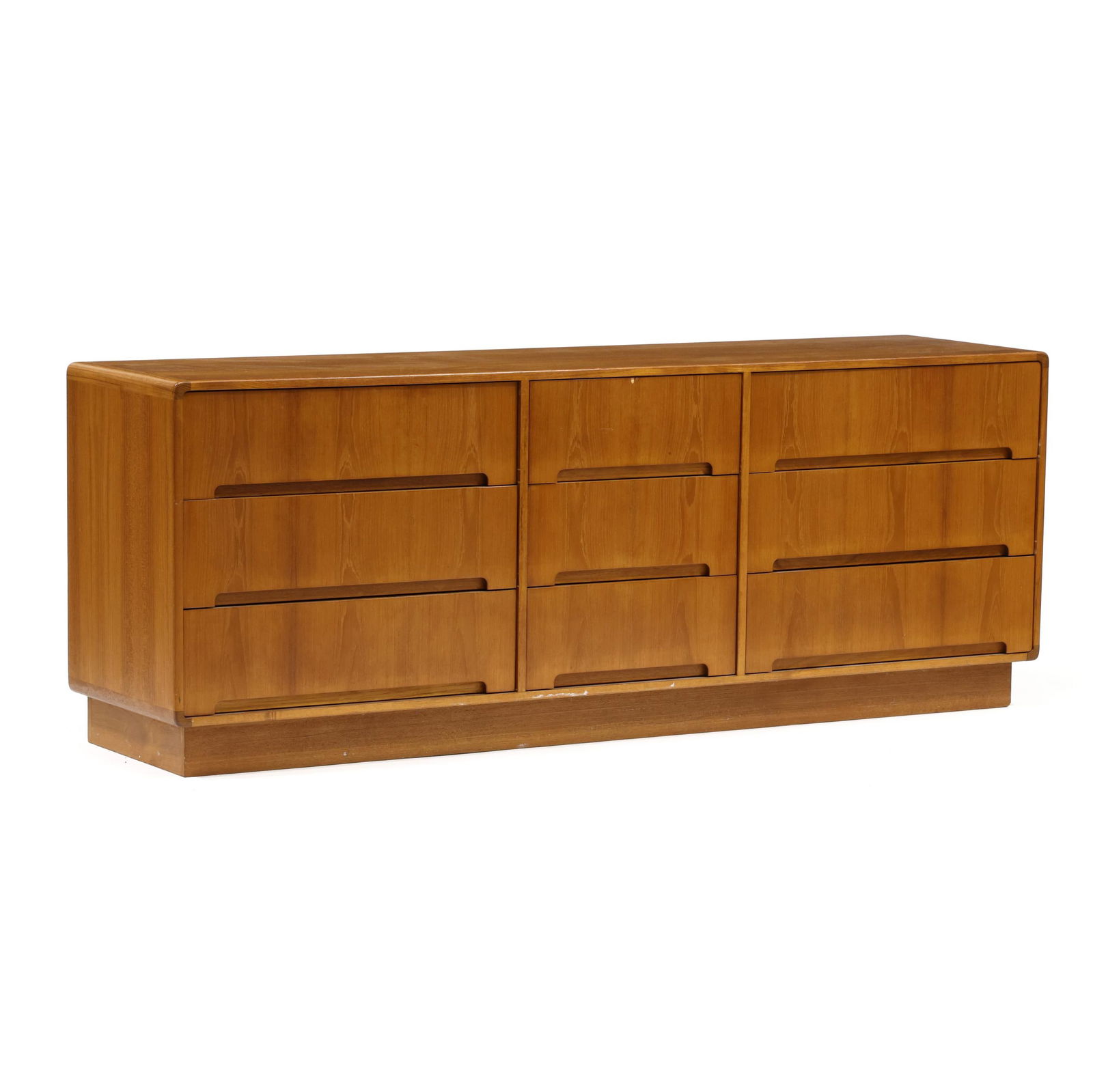 Danish Modern Teak Dresser: Danish Modern Teak Dressercirca 1980, low rectangular form with rounded corners, nine drawers, recessed flush base, finished back, appears unmarked. 29 x 77 x 19 in. Additional high-resolution photos