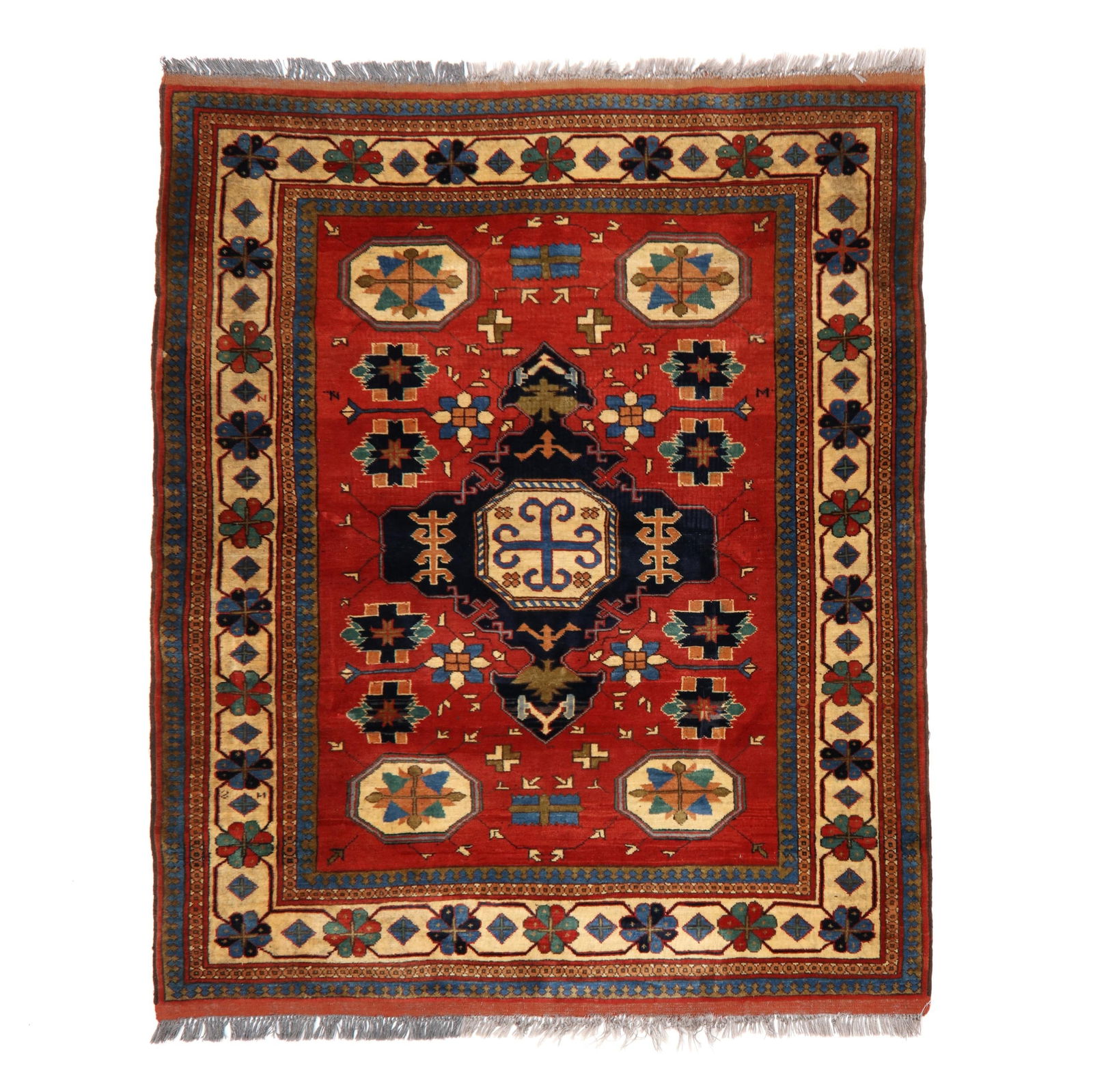 Kazak Area Rug: Kazak Area Rug wool on gray wool foundation, with cross motif in central octagonal medallion on midnight blue, the red field with star motifs in corner octagons, the main tan border with repeating