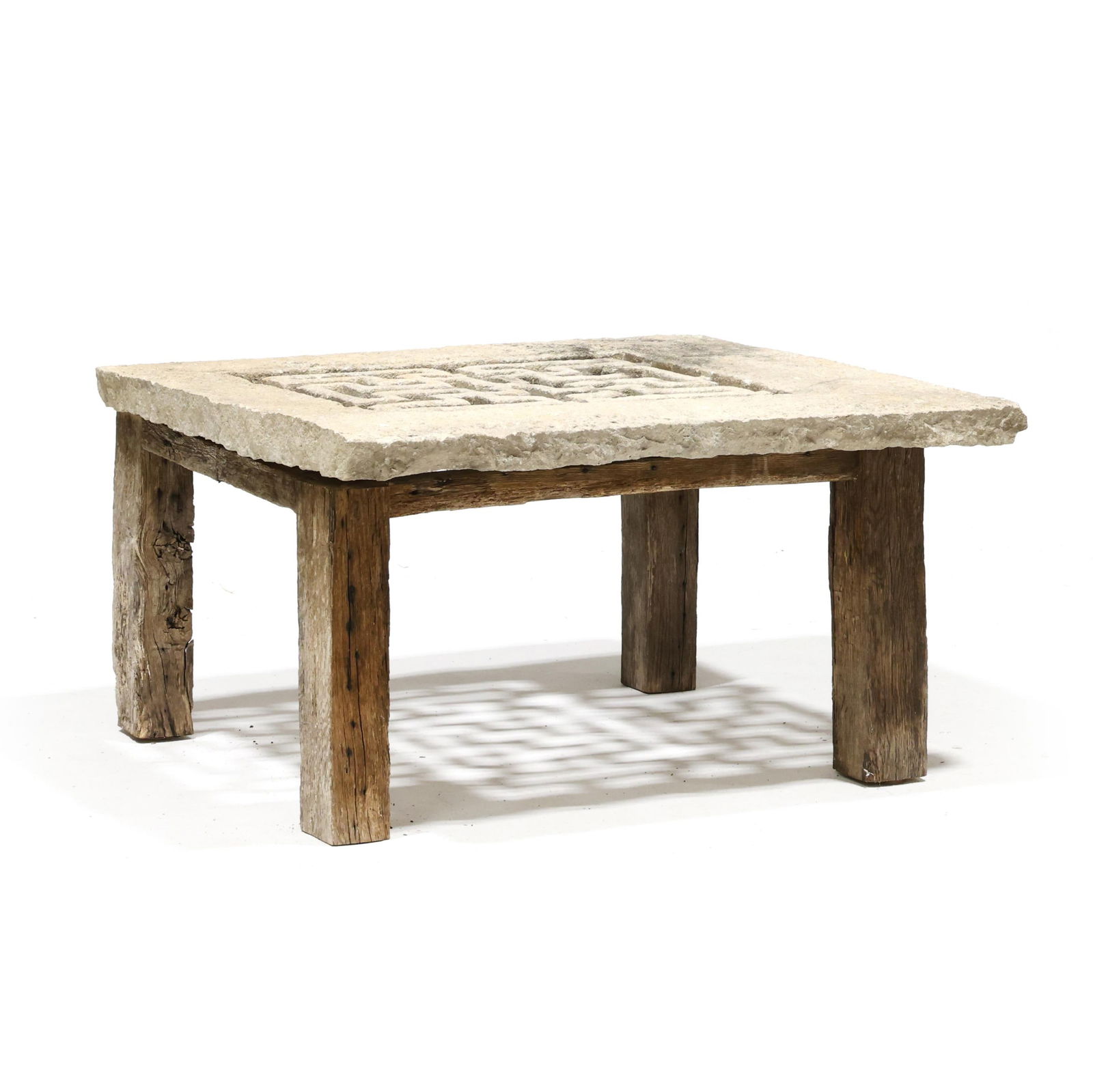 Repurposed Carved Stone Architectural Panel Table: Repurposed Carved Stone Architectural Panel Table19th century or earlier carved Balinese stone panel (likely ventilation) set on a custom wood stand formed from antique French beams. 20 x 40 x 36 in.