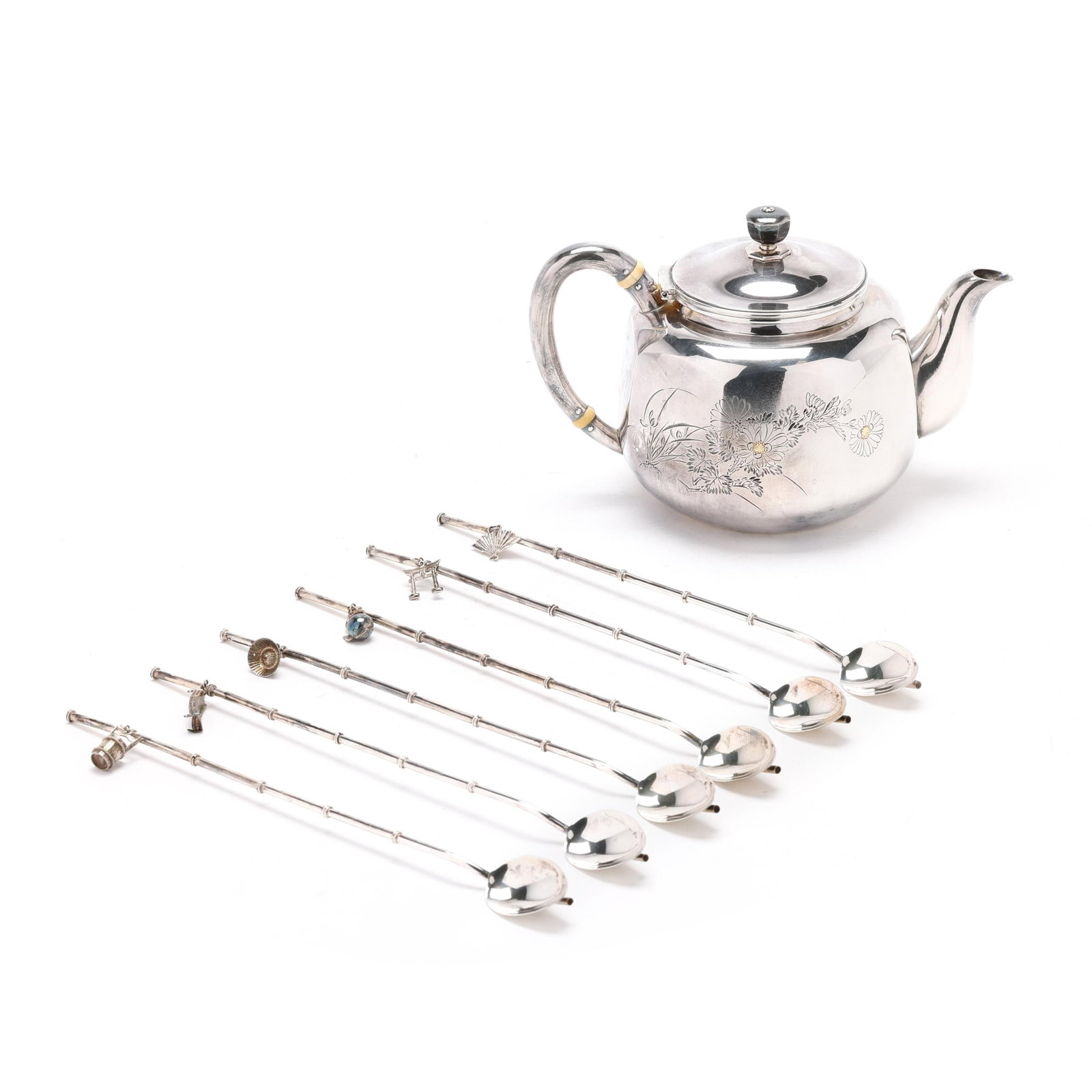 Japanese Silver Teapot and Cased Set of Stirrers: Japanese Silver Teapot and Cased Set of Stirrers20th century, the teapot with engraved two-toned trees and blossoms, with character marks to the underside (5 x 7 1/4 x 4 1/2 in.); the set of (6) stirr