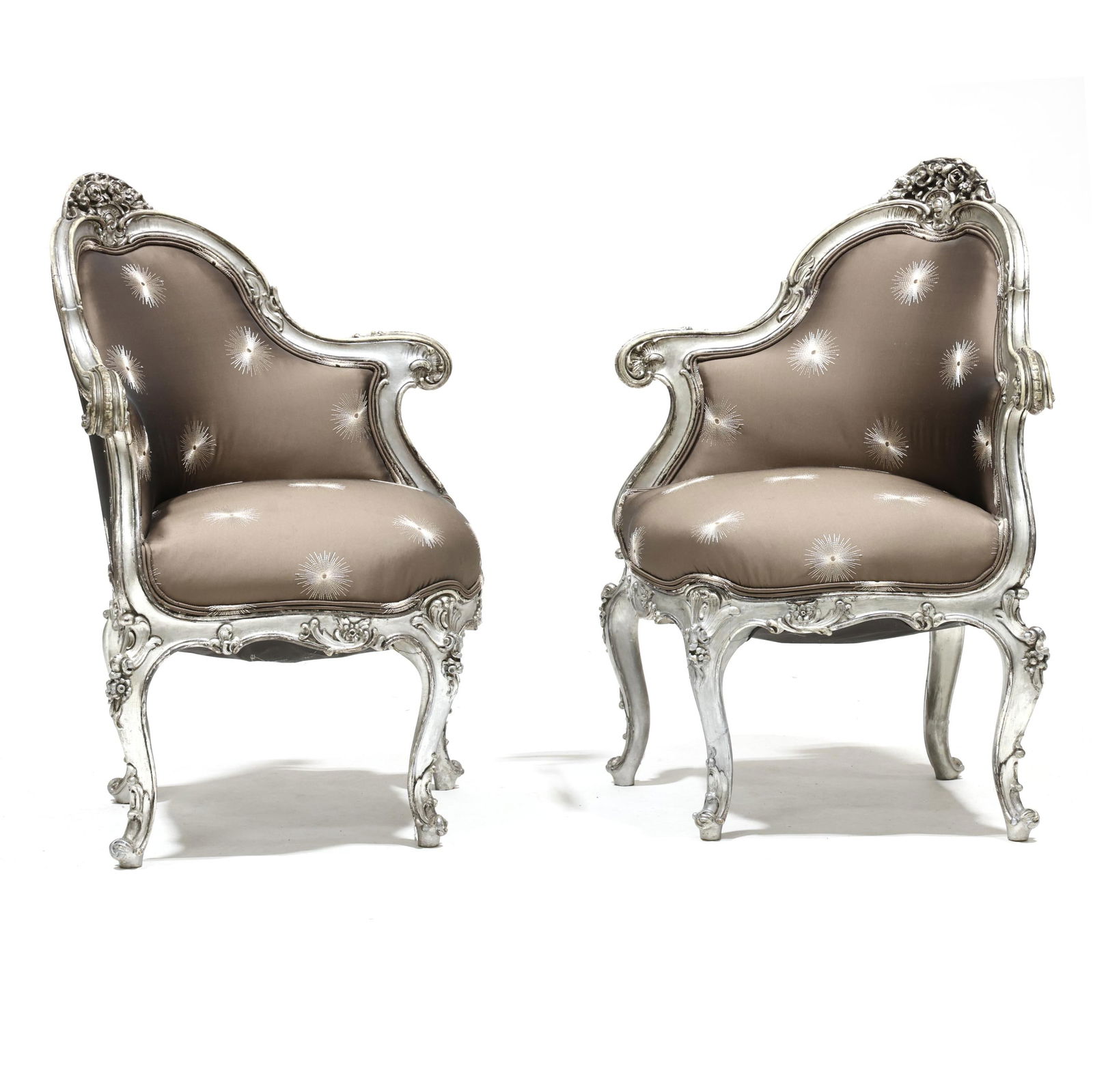Pair of Louis XV Style Carved and Silvered Corner Bergeres: Pair of Louis XV Style Carved and Silvered Corner Bergeres late 20th century, carved wood frames with silver leaf, embroidered sunburst upholstery, four cabriole legs. 35 x 29 x 22 in. Private