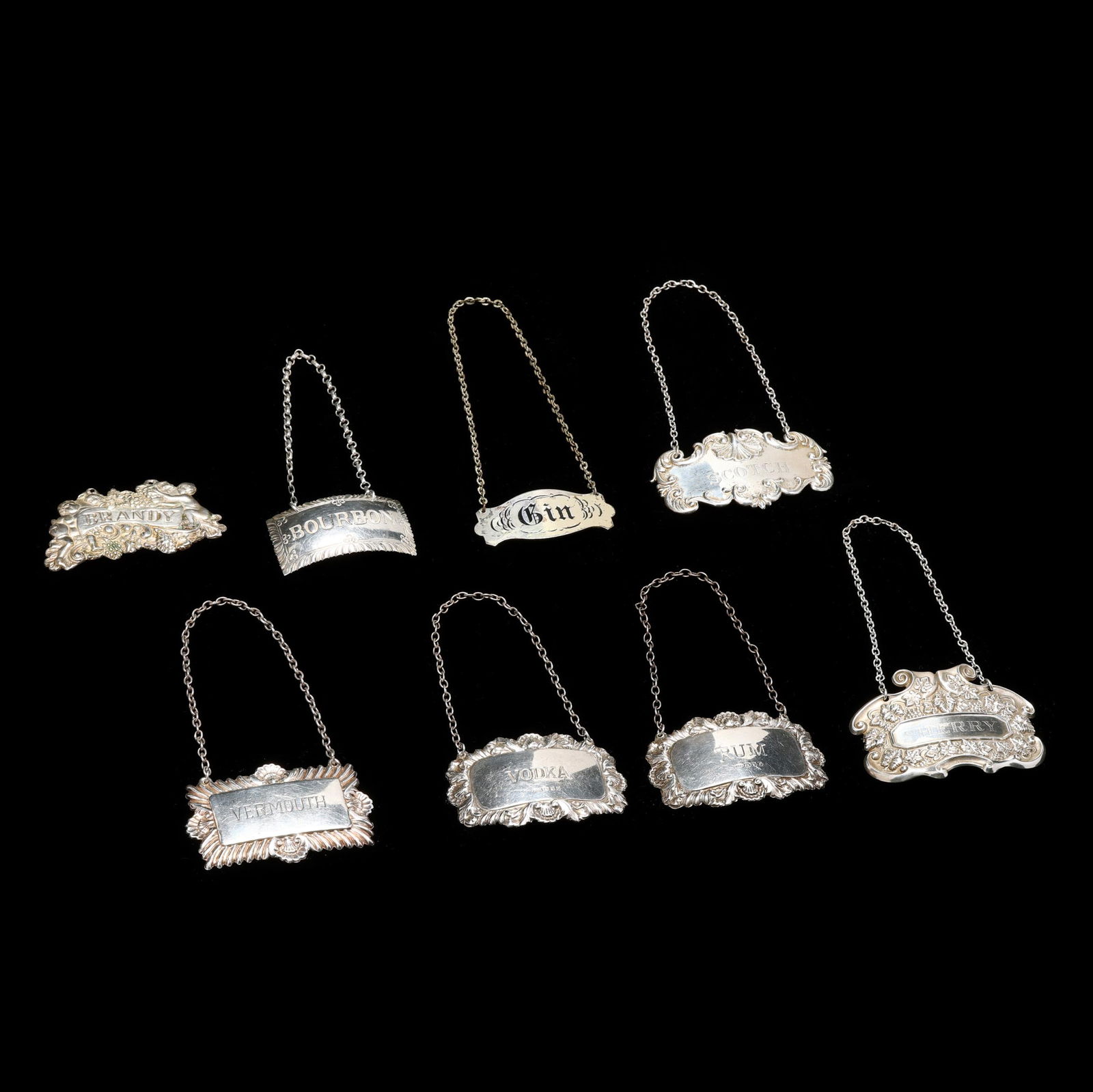 A Group of Eight Silver Liquor Bottle Tags (1 of 8)