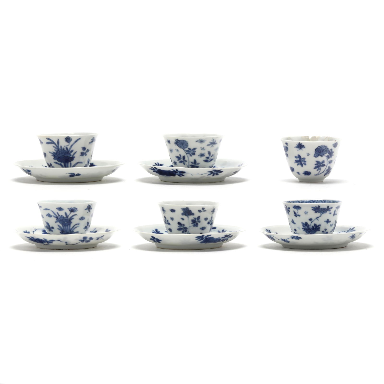 A Set of Six Chinese Kangxi Blue and White Teacups and Five Saucers with Flora: A Set of Six Chinese Kangxi Blue and White Teacups and Five Saucers with FloraKangxi period (1662-1722), porcelain hand-painted in underglaze blue with delicate floral blooms, the center of each sauce
