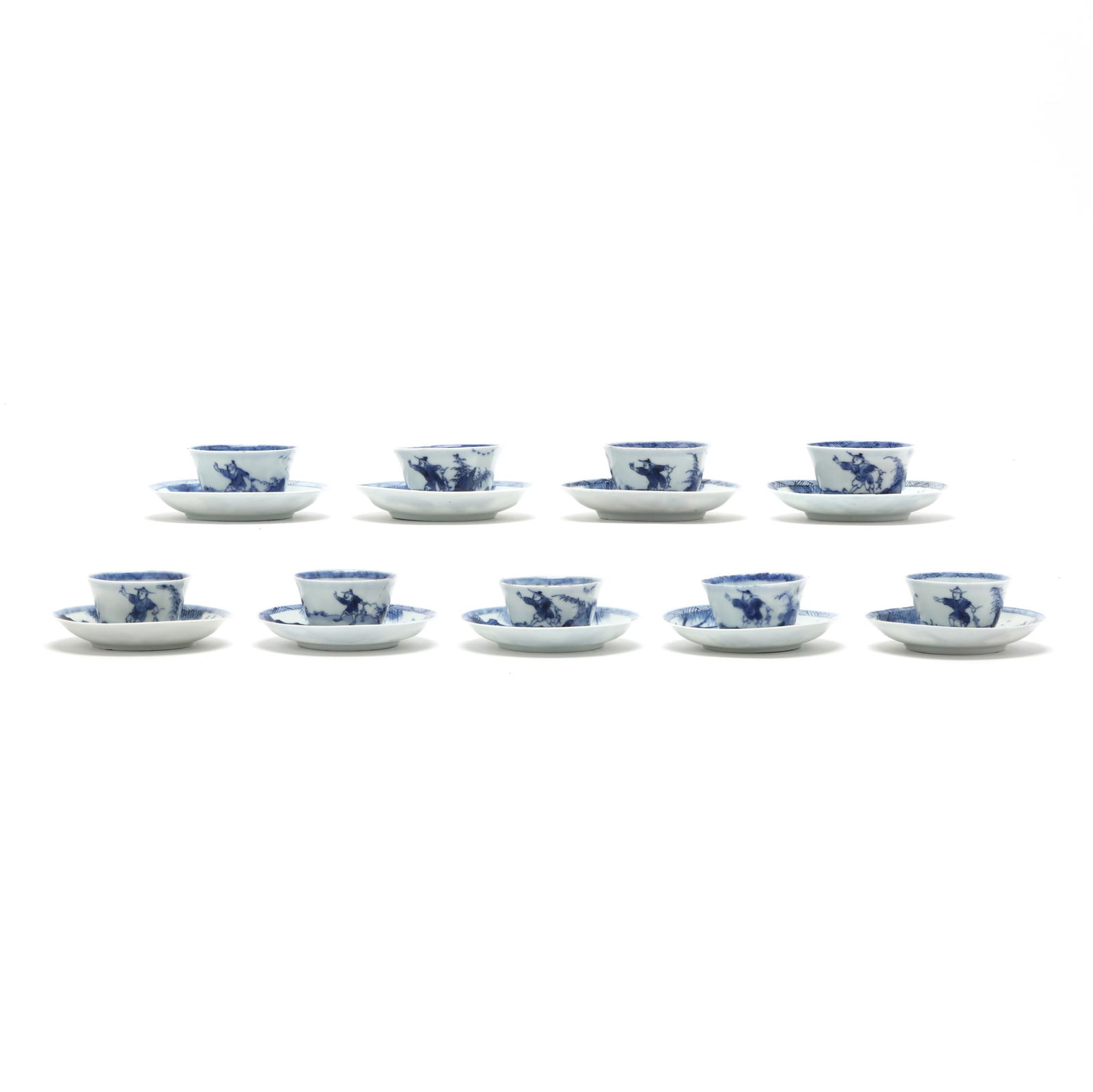 A Set of Nine Chinese Kangxi Blue and White Cups with Saucers: A Set of Nine Chinese Kangxi Blue and White Cups with SaucersKangxi period (1662-1722), porcelain hand-painted in underglaze blue, nine small tea or wine cups with saucers, all decorated with two figu