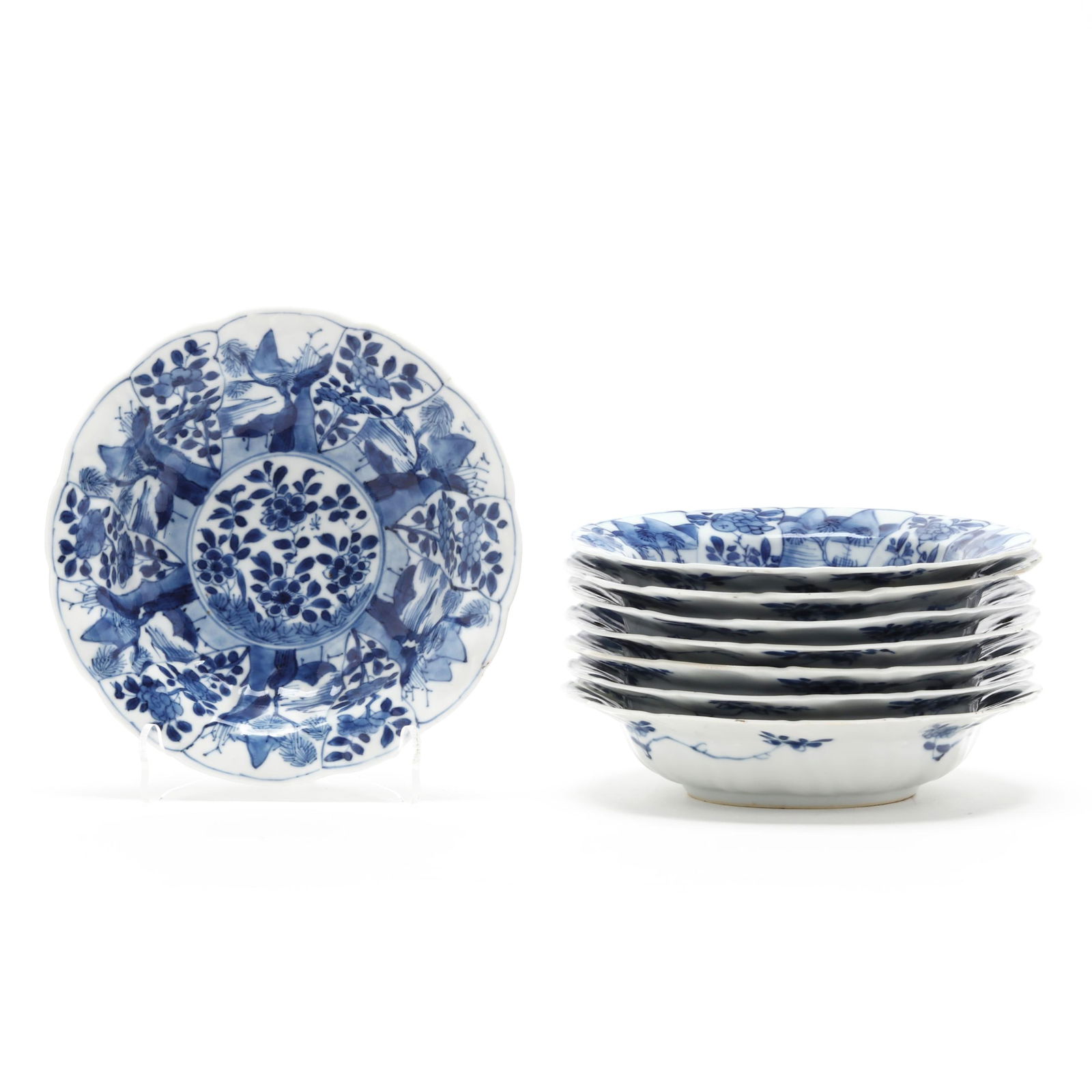 A Set of Eight Chinese Kangxi Blue and White Bowls: A Set of Eight Chinese Kangxi Blue and White Bowls Kangxi period (1662-1722), porcelain hand-painted in underglaze blue, each bowl with lush blooming flowers to the center well surrounded by shaped pe