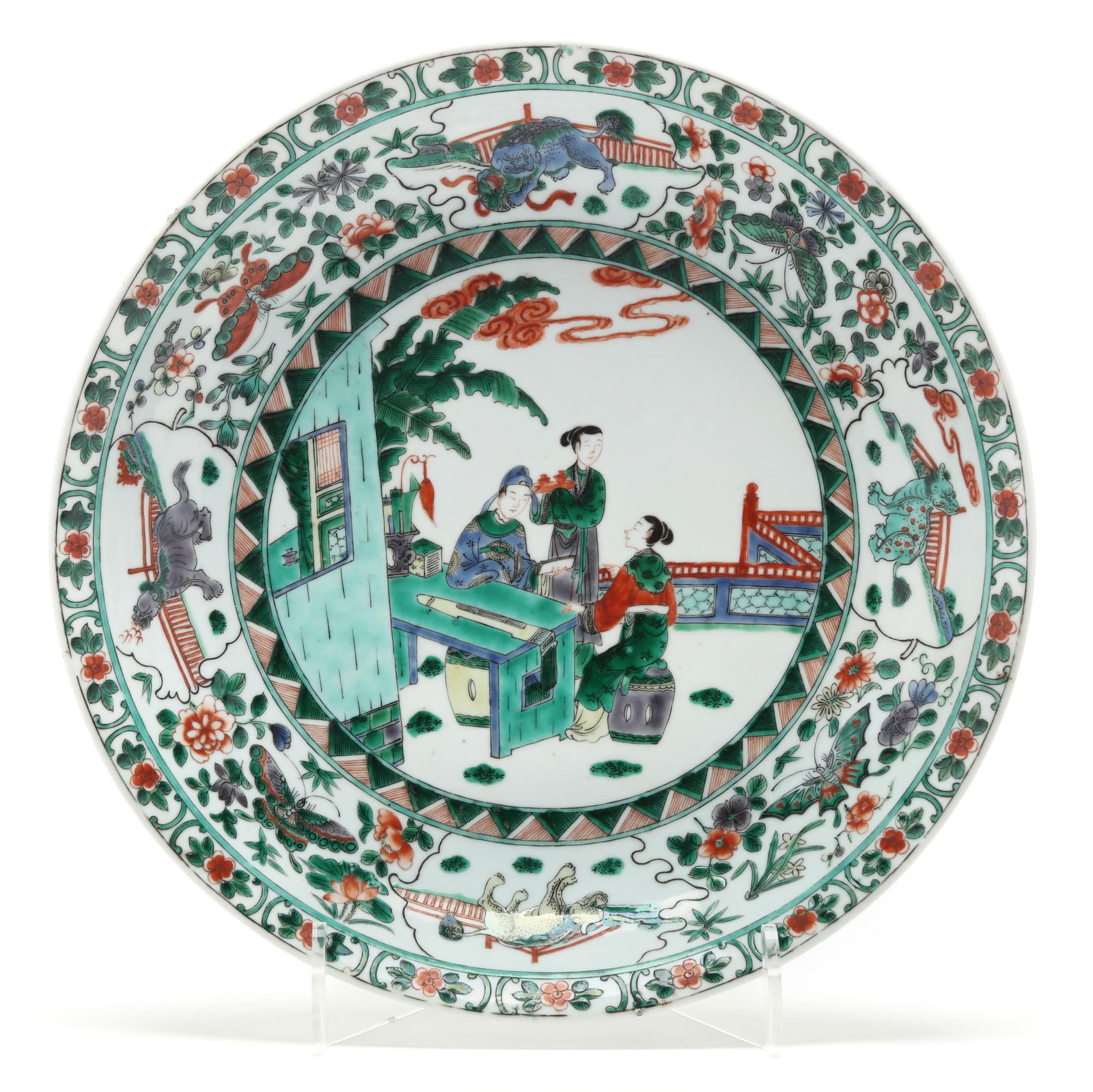 A Chinese Famille Verte Porcelain Charger: A Chinese Famille Verte Porcelain Charger Qing dynasty, probably Kangxi period (1662-1722), a porcelain charger hand-painted in the famille verte palette with three elegant figures in an architectural