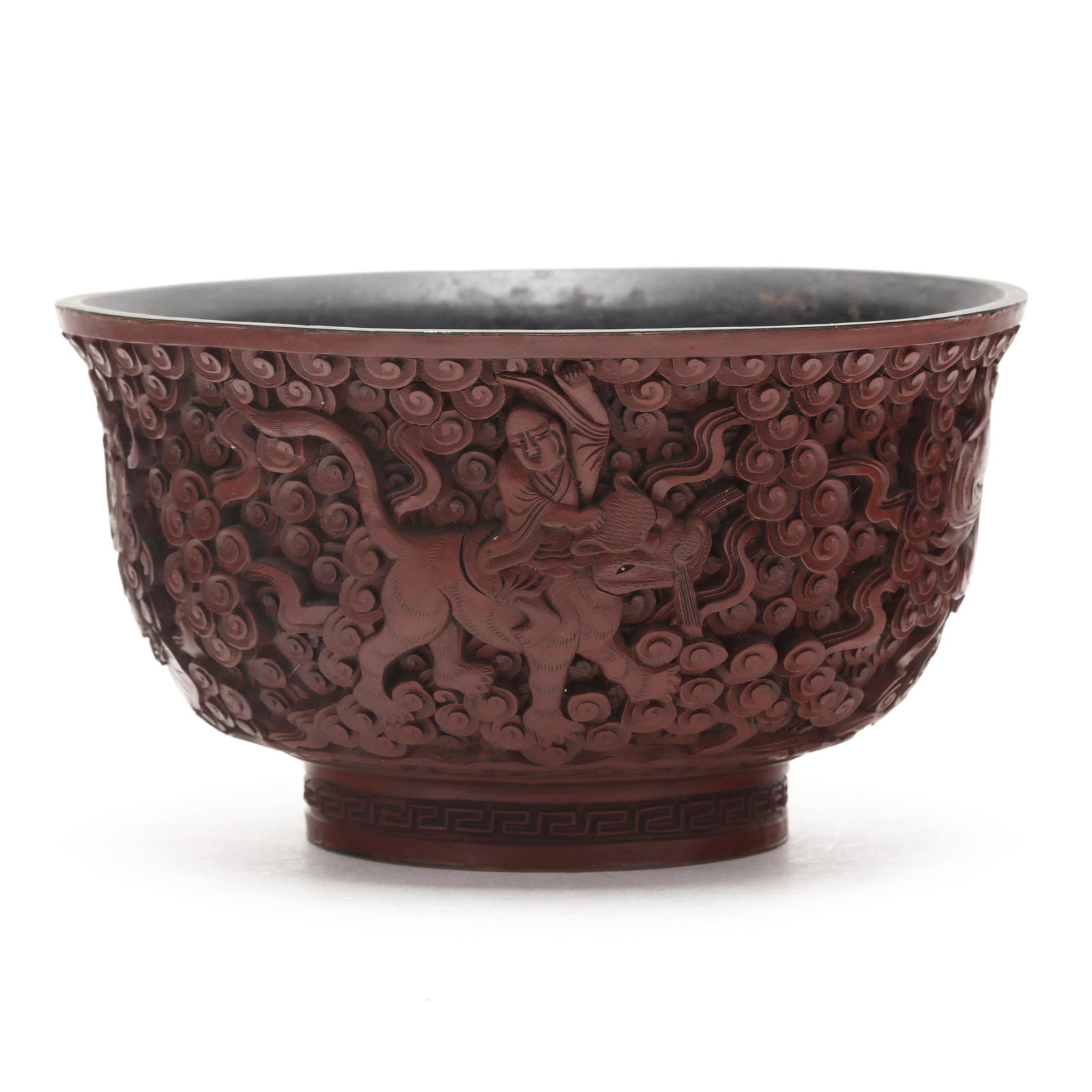A Chinese Carved Lacquer Bowl with Deities: A Chinese Carved Lacquer Bowl with DeitiesQing Dynasty (1644-1912), late 19th or early 20th century, an exquisitely carved lacquer bowl with Daoist Figures amidst swirling cloud, key fret carving enci
