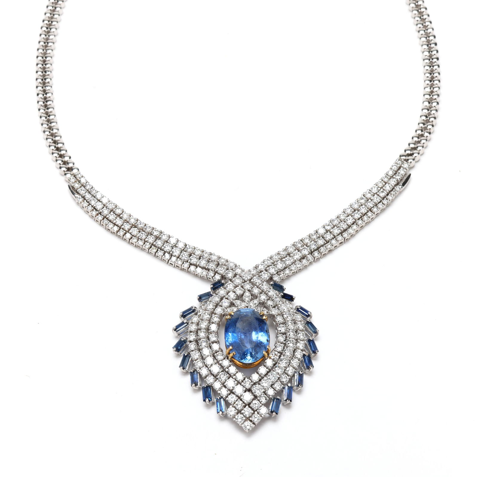 White Gold, Sapphire, and Diamond Necklace: White Gold, Sapphire, and Diamond Necklacethe white gold necklace prong set in gold with an oval cut sapphire (18.87 x 13.82 x 9.00mm) weighing approximately 18.5 carats within a crossover surround of
