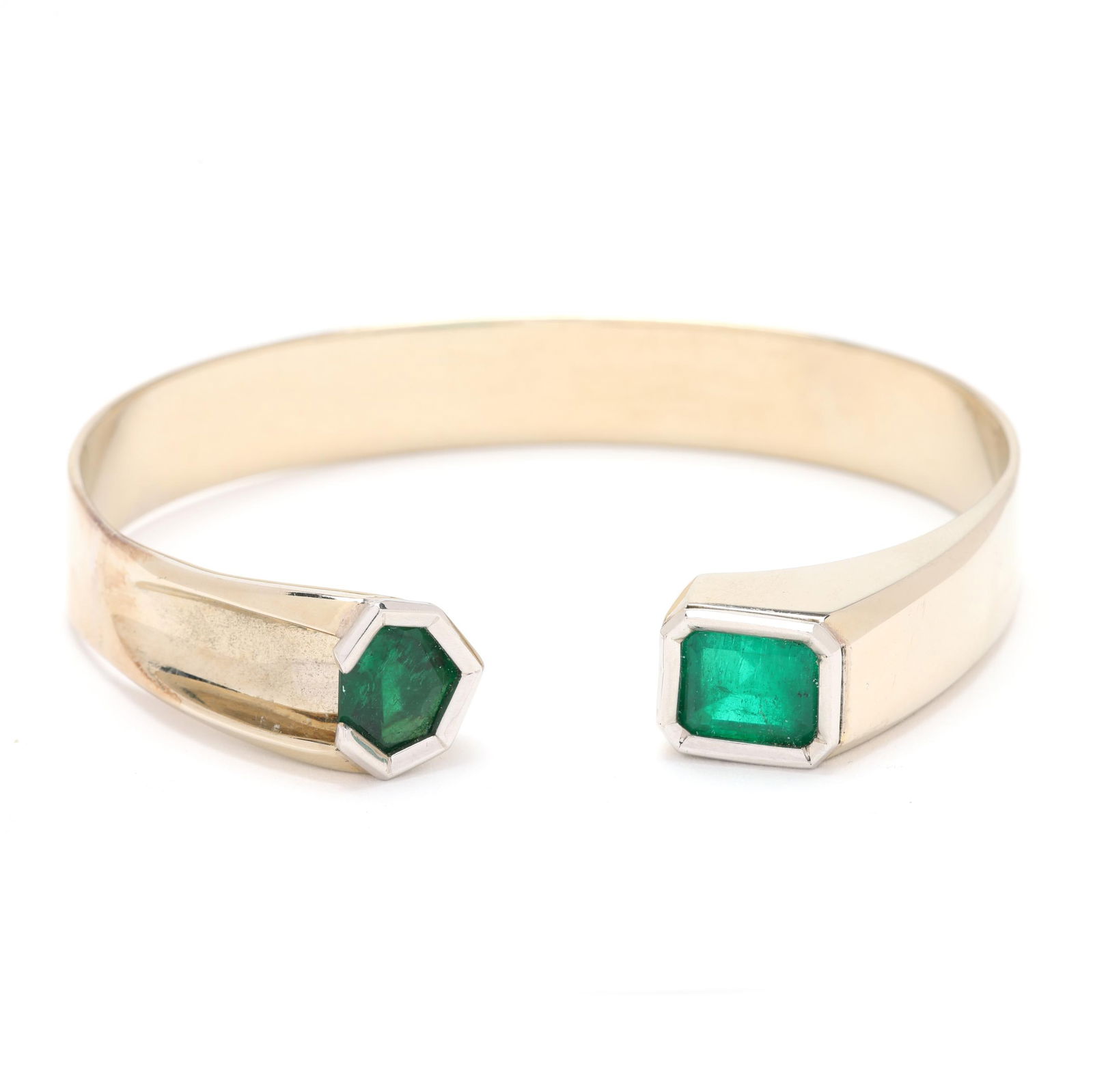 White Gold and Emerald Cuff Bracelet, Jewelsmith: White Gold and Emerald Cuff Bracelet, Jewelsmiththe white gold cuff bracelet set to the terminals with a emerald cut emerald (9.5 x 7.9 x 6.38mm) and a shield cut emerald (8.7 x 9.4 x 4.70mm), signed