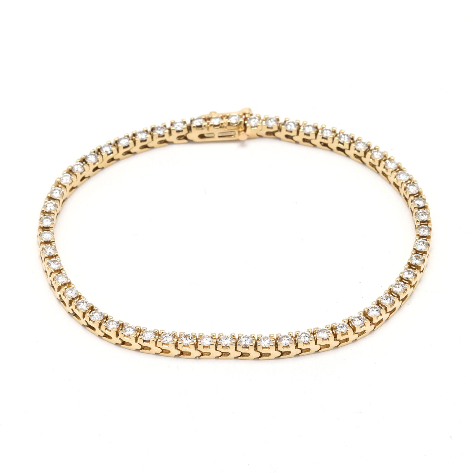 Gold and Diamond Line Bracelet: Gold and Diamond Line Bracelet set with full cut round diamonds weighing approximately 3.25 total carats (I-J color, SI2-I1 clarity), completed with an integrated box clasp and figure eight safety,