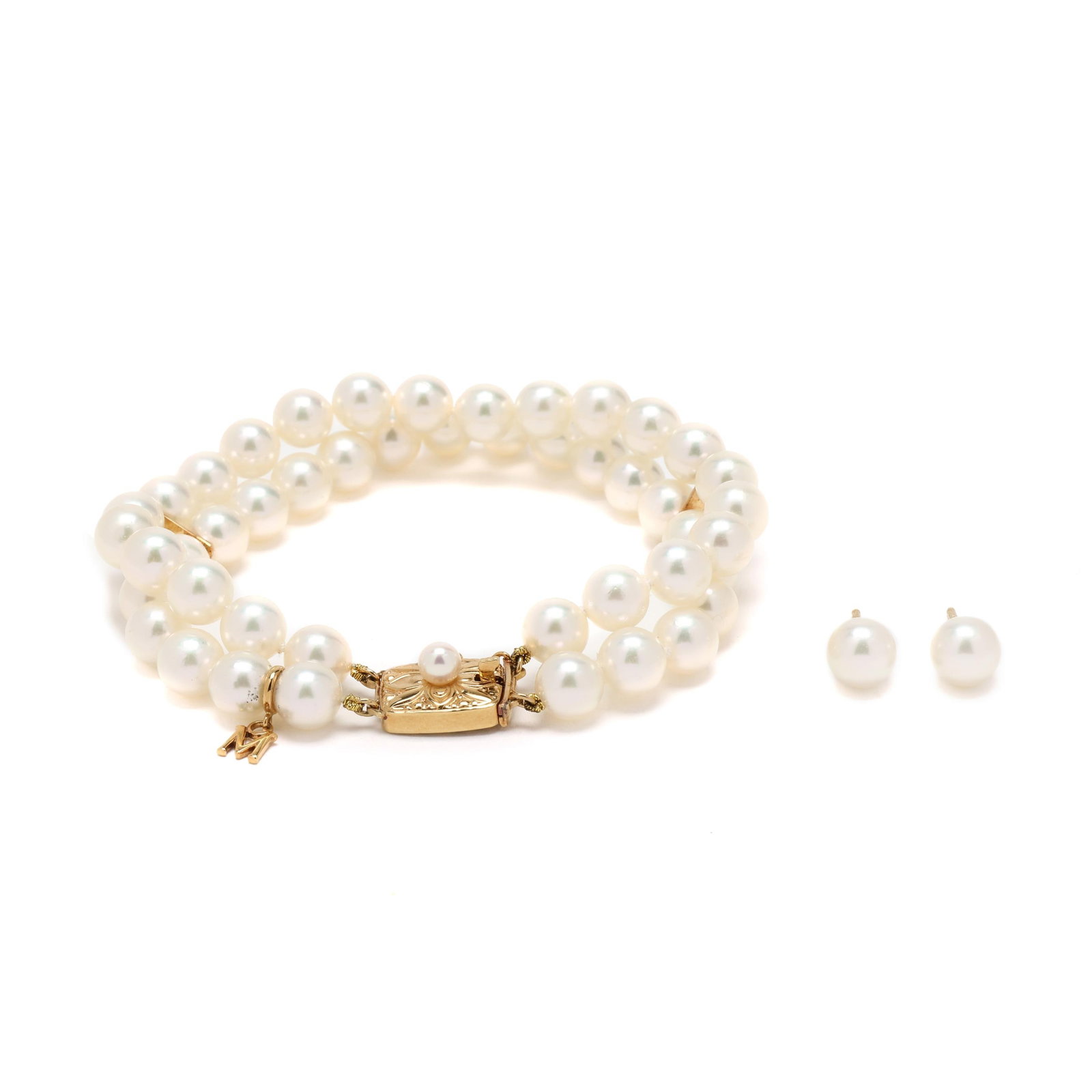 Gold and Pearl Bracelet and Stud Earrings, Mikimoto: Gold and Pearl Bracelet and Stud Earrings, Mikimototo include: a double strand pearl bracelet, each strung knotted with (23) round cultured pearls (6.5 - 7.0mm), suspending a gold 'M' charm, completed