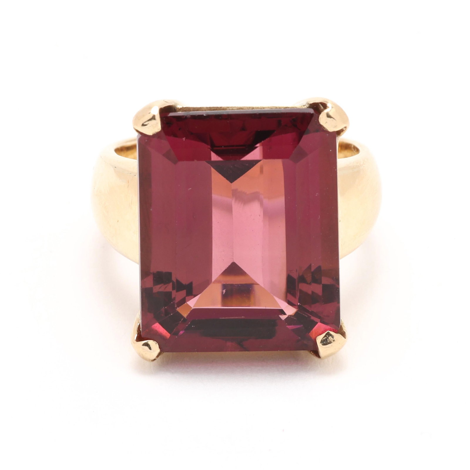 Gold and Tourmaline Ring: Gold and Tourmaline Ring centered on a prong set emerald cut tourmaline (16.82 x 13.41 x 7.86mm) weighing approximately 14.50 carats with a round cut tourmaline flush set to each prong, stamped 18K,