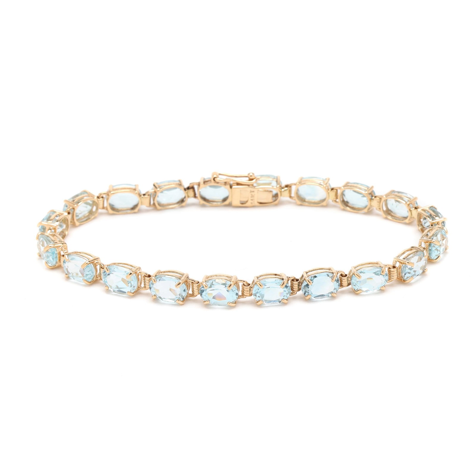 Gold and Blue Topaz Line Bracelet: Gold and Blue Topaz Line Bracelet set with oval cut blue topaz (7 x 5mm) weighing approximately 20 total carats, completed with a box clasp and figure eight safety, stamped 14KT. 7 in. 6.5 dwt. 