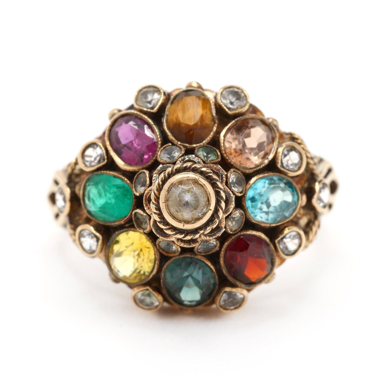 Gold and Gem-Set Ring: Gold and Gem-Set Ring the gold Mughal style ring set with colorless gemstones within a surround of oval cut gemstones to include: emerald, ruby, tiger's eye quartz, garnet, and others, stamped 18K /