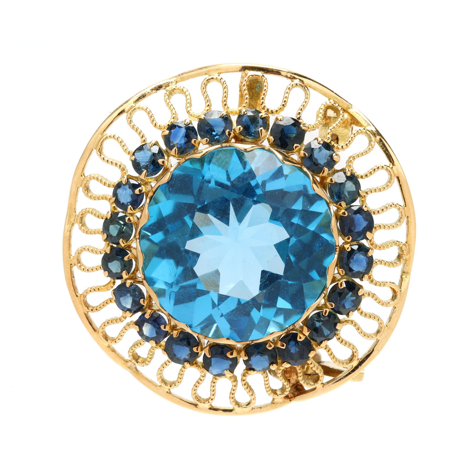 Gold and Gem-Set Brooch: Gold and Gem-Set Broochcentered on a round cut blue topaz (18mm) weighing approximately 20.0 carats, within a surround of round cut sapphires (3mm) weighing approximately 2.50 total carats, further se