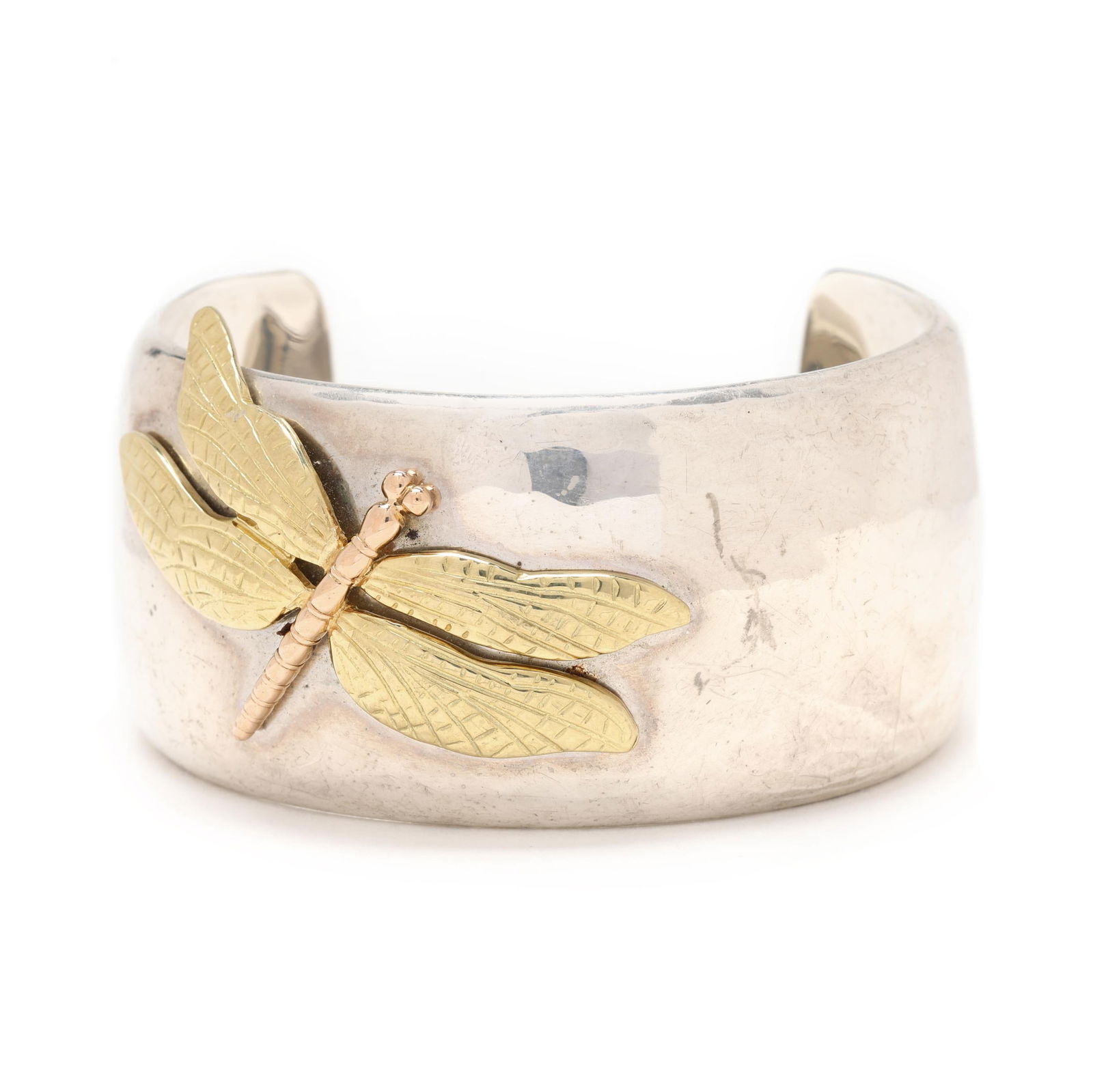 Silver and Gold Dragonfly Cuff, Tiffany & Co.: Silver and Gold Dragonfly Cuff, Tiffany & Co. circa 2001, from the Tiffany Nature collection, the wide hammered silver cuff bracelet with gold dragonfly appliqué, signed, numbered, and stamped 925 75