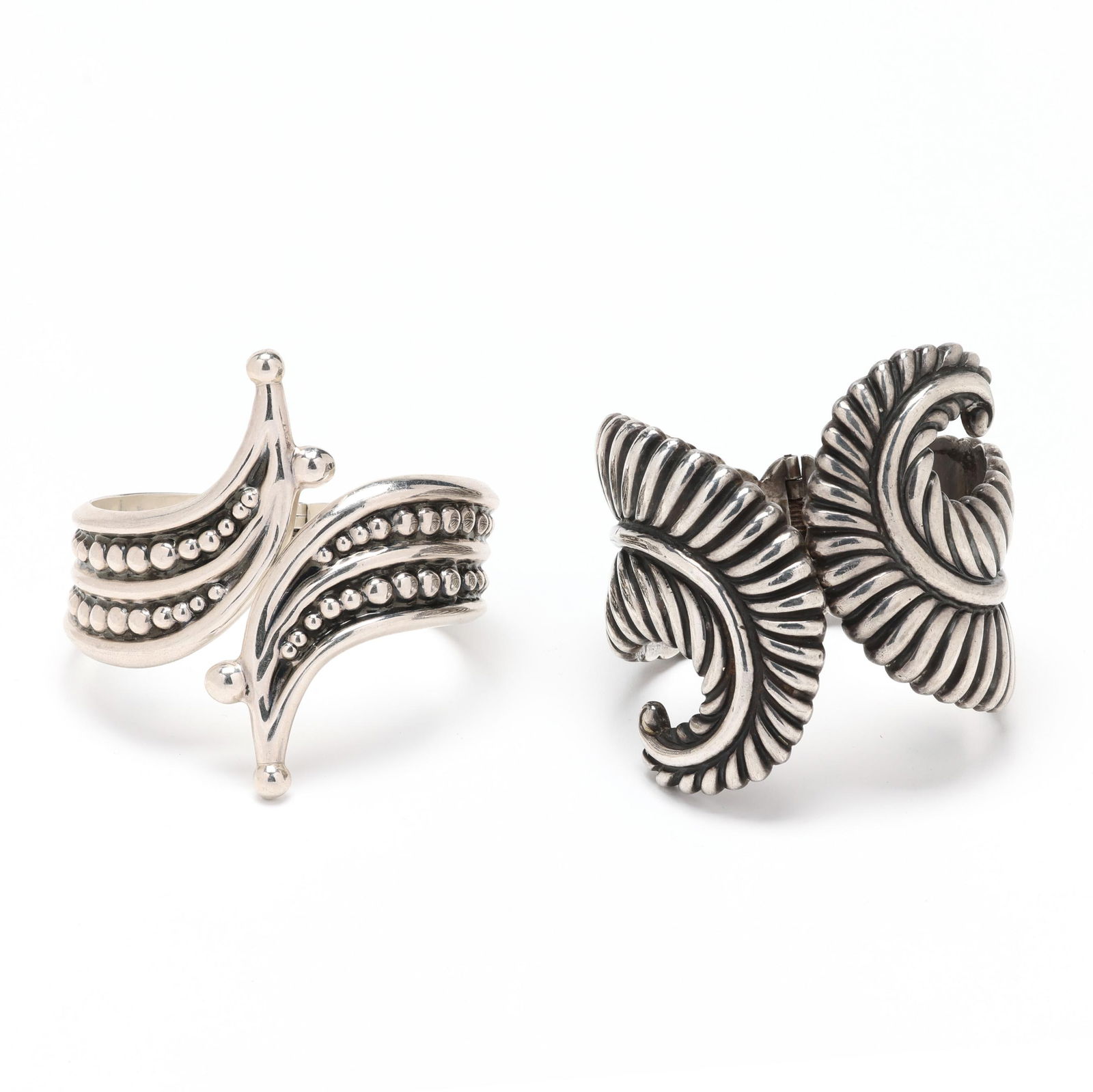 Two Signed Silver Cuff Bracelets, Mexico: Two Signed Silver Cuff Bracelets, Mexico to include: a hinged bangle in bypass form with beaded motif, stamped TH-155 / Mexico / 925 (2.75 x 7 in.); and a hinged bangle in bypass form with feather