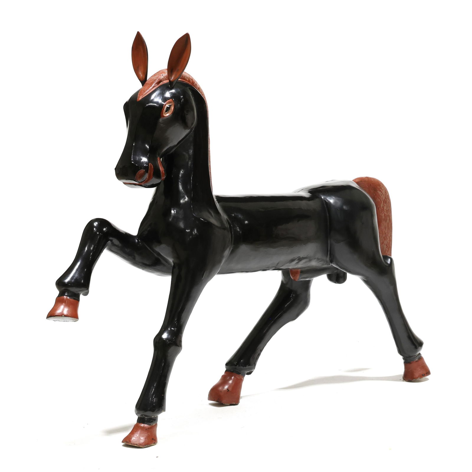 Large Art Deco Style Carved and Lacquered Sculpture of a Horse: Large Art Deco Style Carved and Lacquered Sculpture of a HorseThailand, late 20th century, hand carved and finely lacquered wood in high polished black with red highlights, removable ears, finished on
