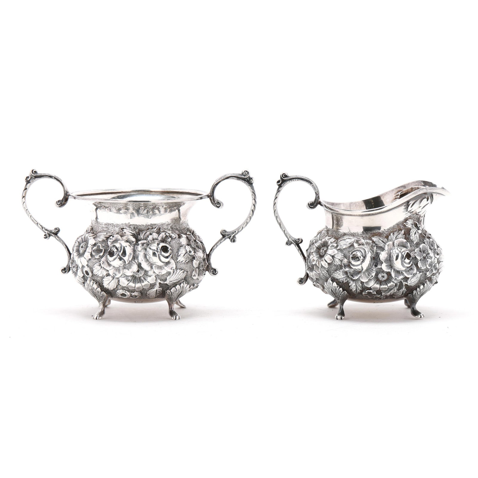 Repousse Sterling Silver Creamer and Sugar by A. G. Schultz & Co.: Repousse Sterling Silver Creamer and Sugar by A. G. Schultz & Co.early 20th century, pattern number 201, featuring hand-chased floral decoration on a stippled ground, raised on paw feet, not monogramm