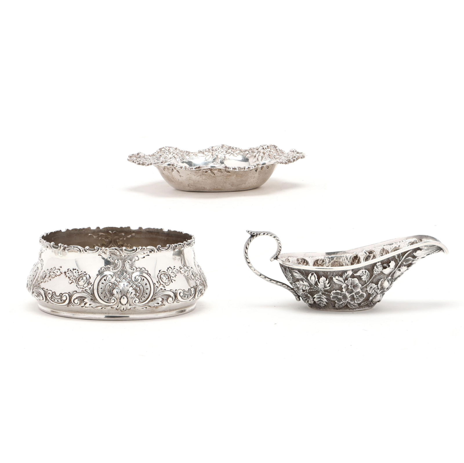 Three Repousse Sterling Silver Serving Items: Three Repousse Sterling Silver Serving Items the first, a bon bon bowl by Howard & Co., New York, pattern number 147, with repousse floral and cartouche decoration, and a c-scroll rim (2 x 5 in.