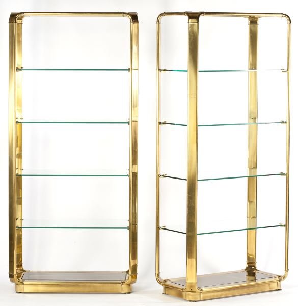 John Widdicomb, Pair of Brass Etageres: John Widdicomb, Pair of Brass Etageresbrass and glass, including four clear shelves and one lower smoky glass shelf, each shelf secured with a brass button, John Widdicomb label to top.80.5 x 37 x 19